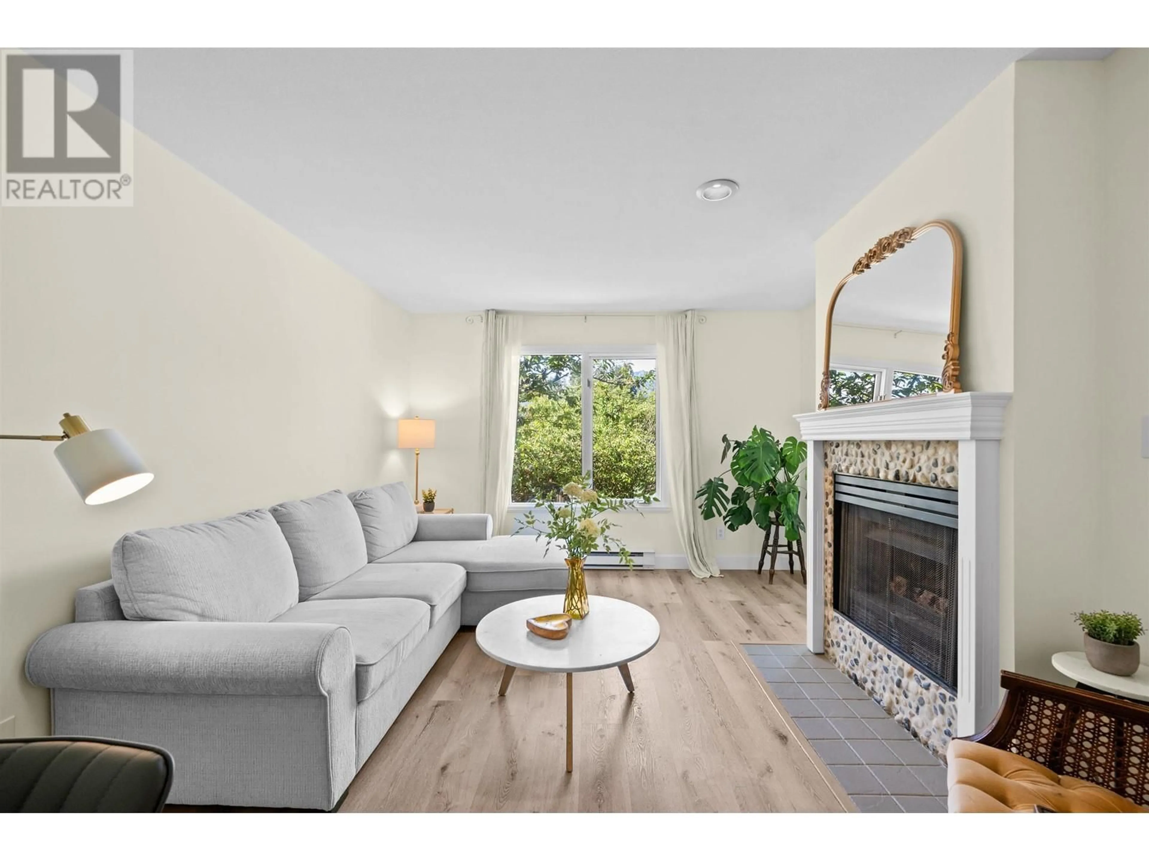 Living room with furniture, wood/laminate floor for 204 - 1528 BOWSER AVENUE, North Vancouver British Columbia V7P2Y3