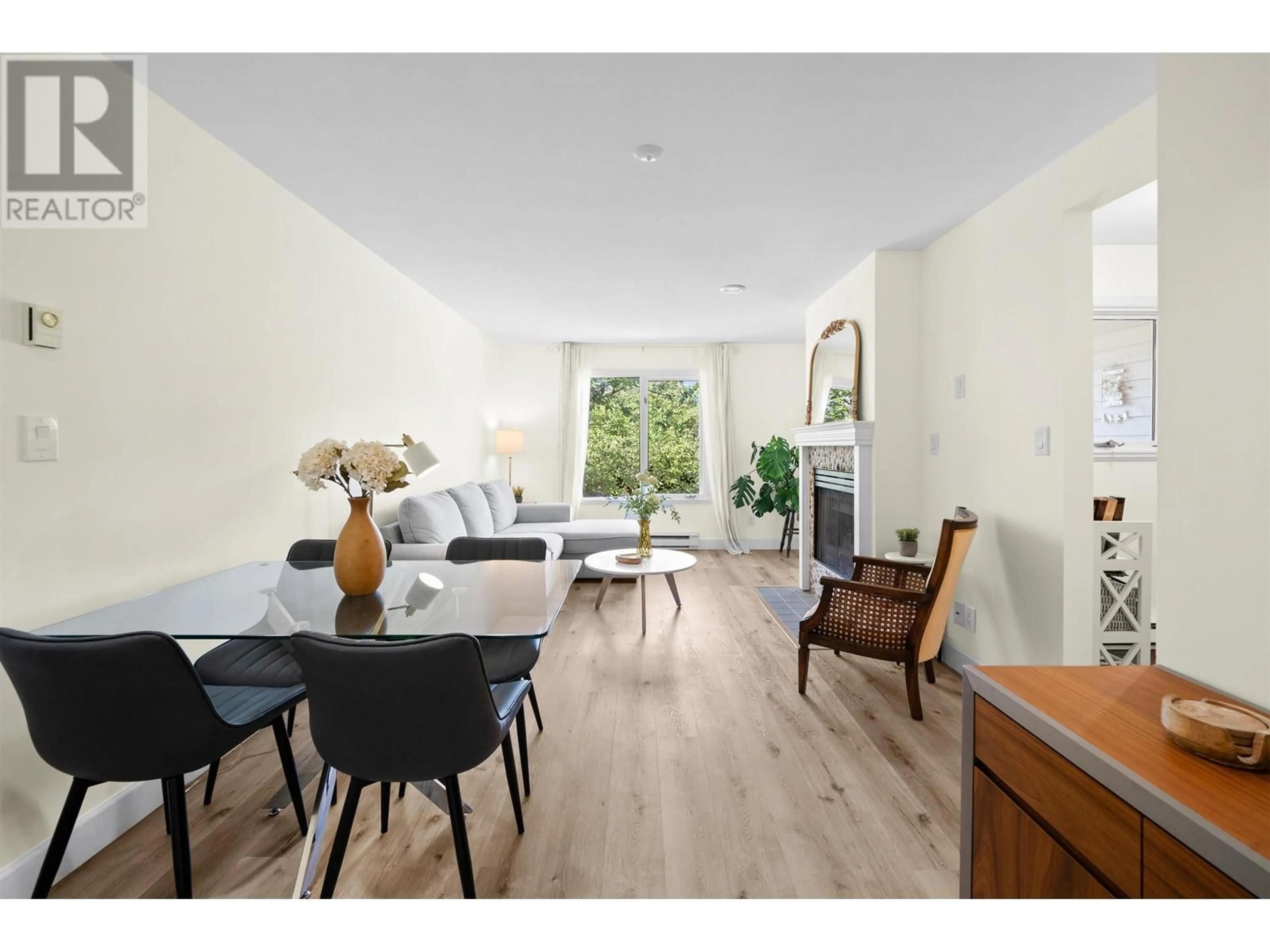 Living room with furniture, wood/laminate floor for 204 - 1528 BOWSER AVENUE, North Vancouver British Columbia V7P2Y3