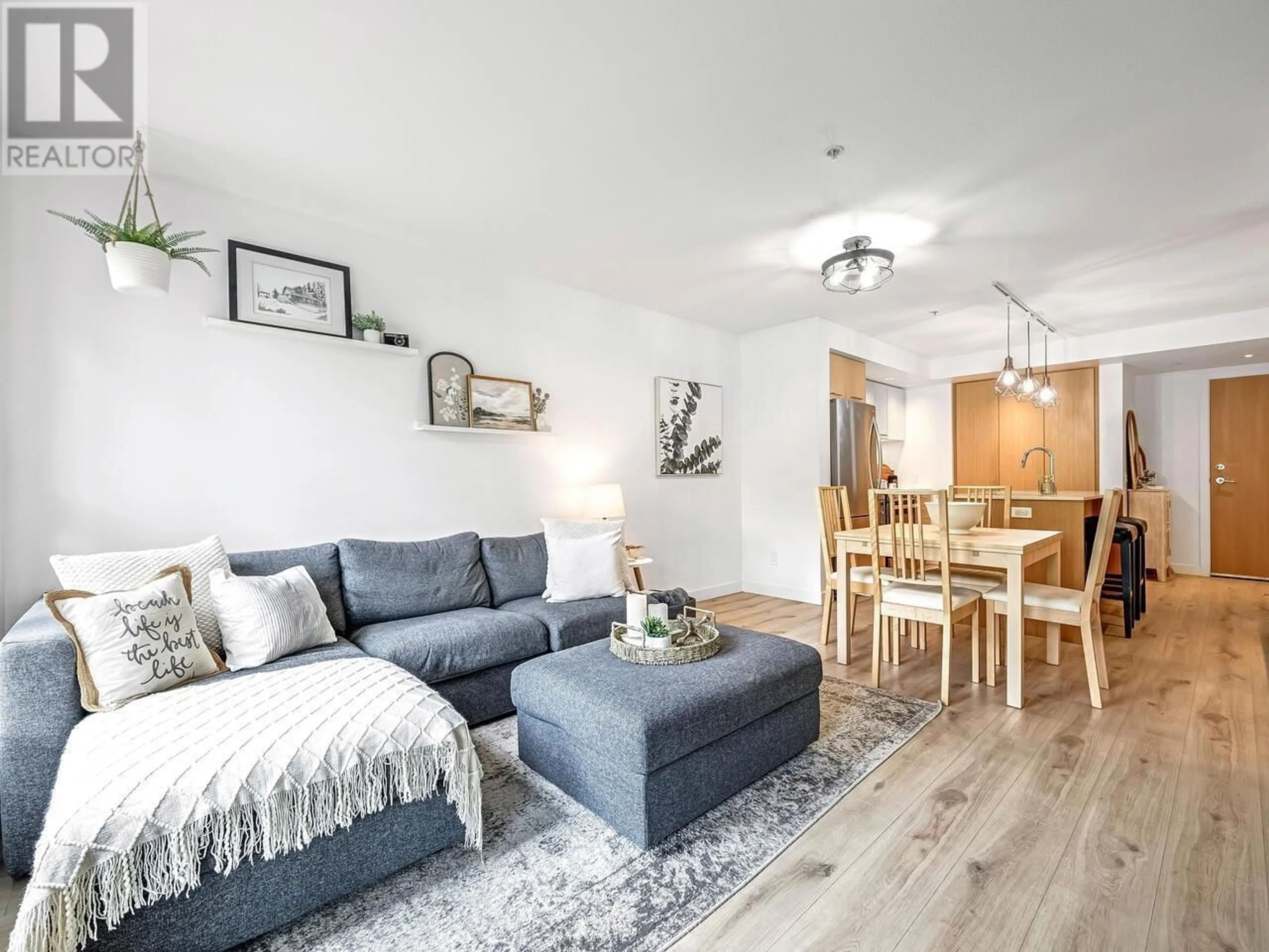 Living room with furniture, wood/laminate floor for 107 - 221 3RD STREET, North Vancouver British Columbia V7L0C1