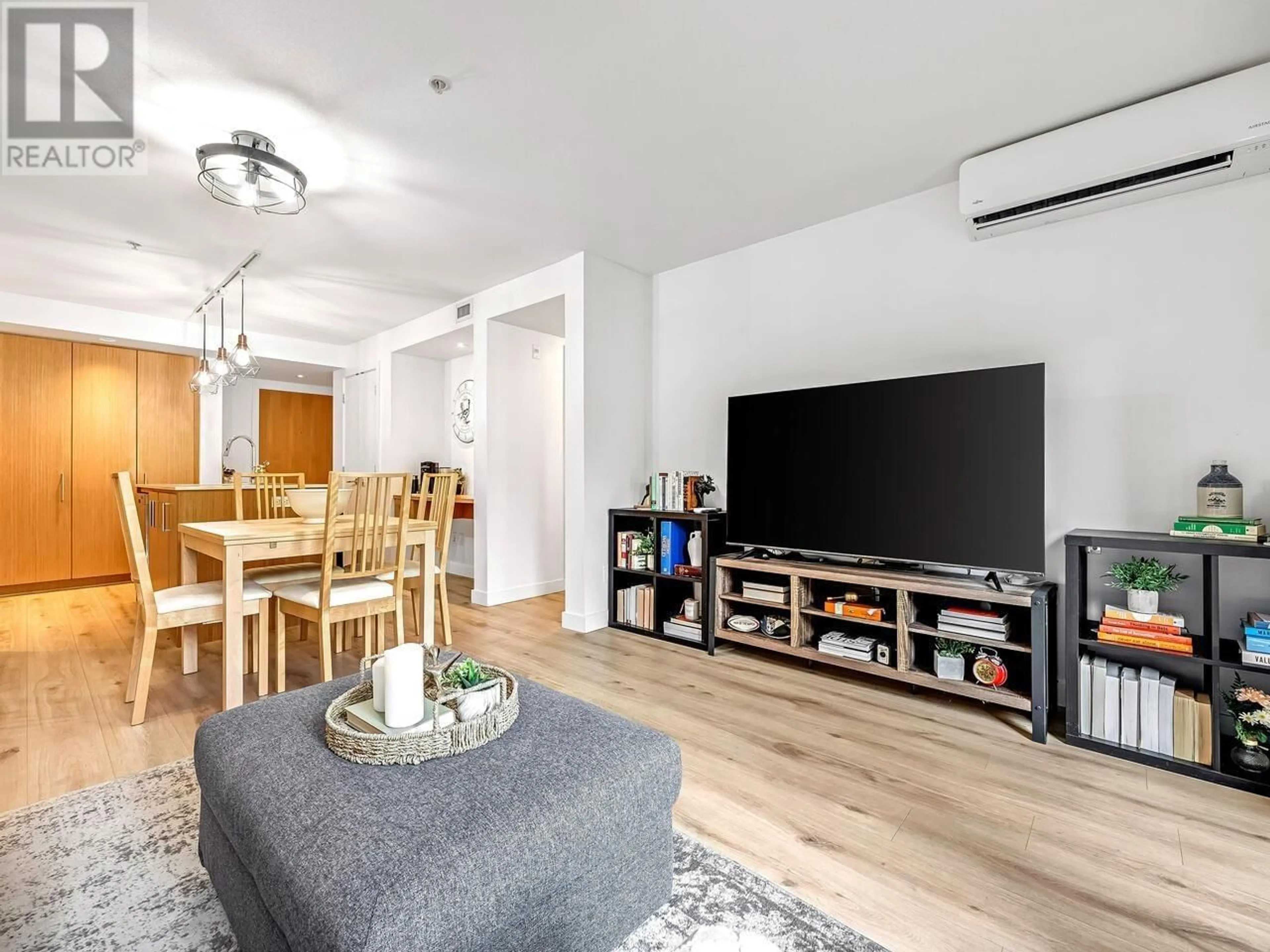 Living room with furniture, wood/laminate floor for 107 - 221 3RD STREET, North Vancouver British Columbia V7L0C1