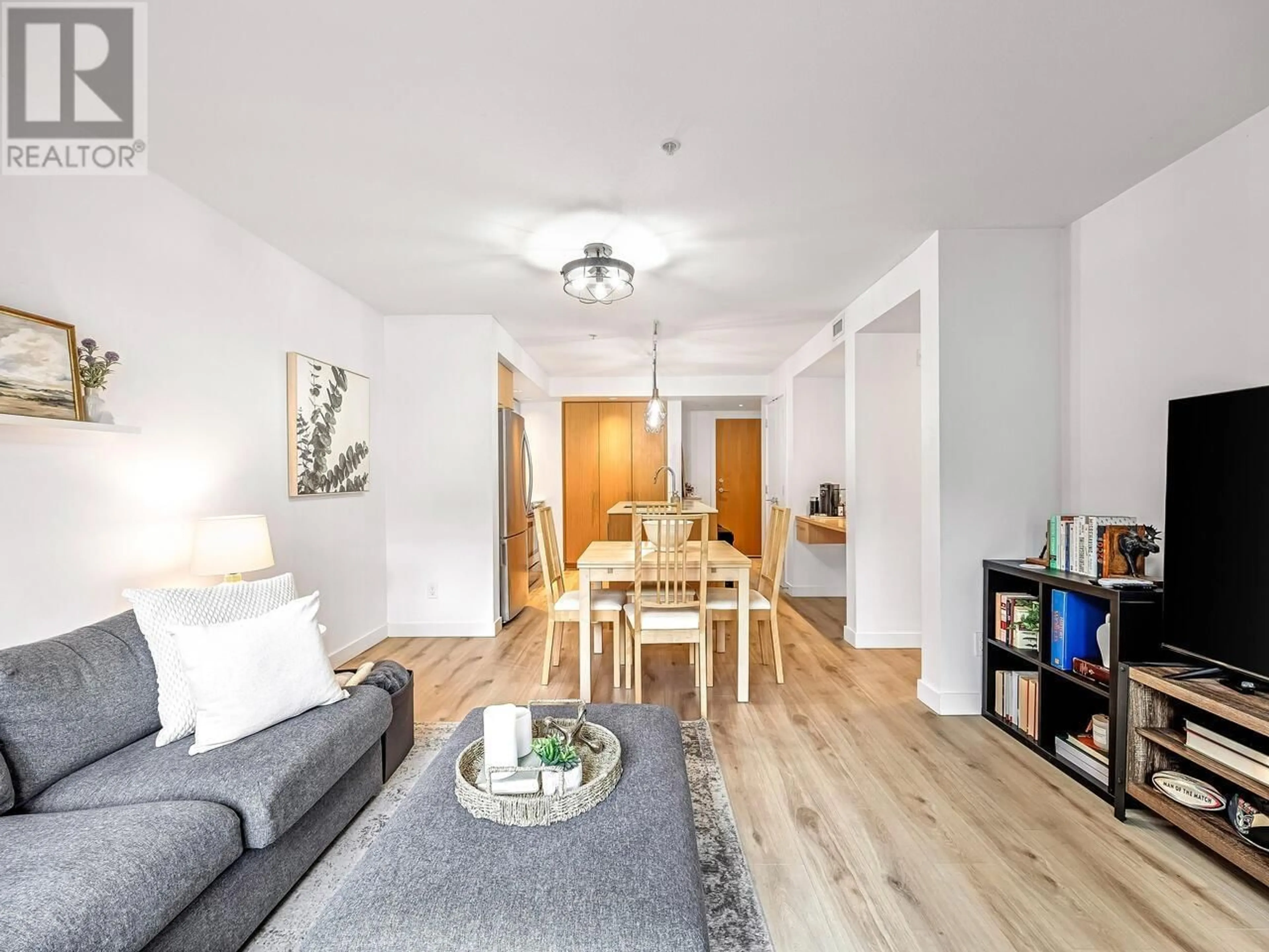 Living room with furniture, wood/laminate floor for 107 - 221 3RD STREET, North Vancouver British Columbia V7L0C1