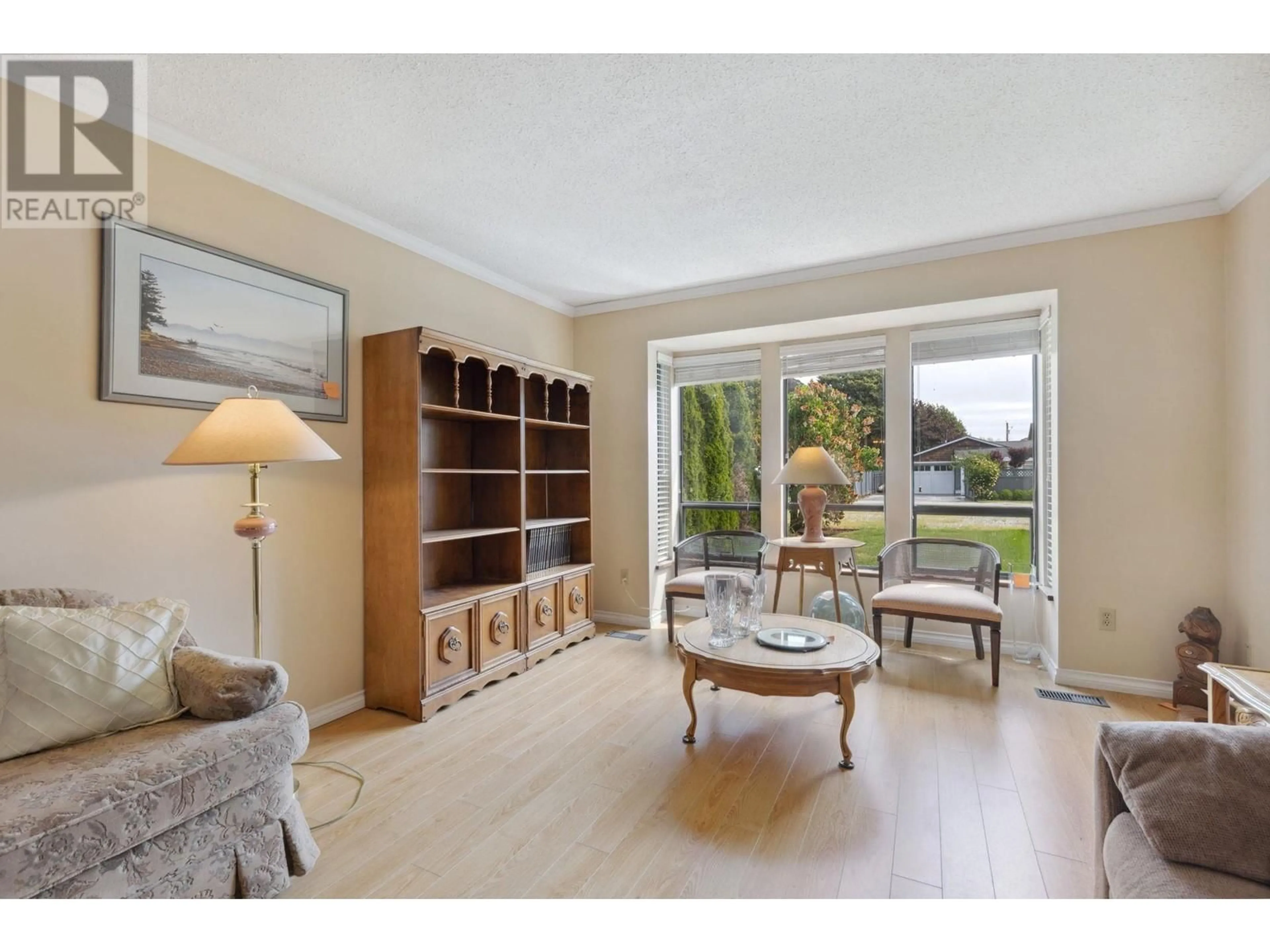 Living room with furniture, wood/laminate floor for 193 67 STREET, Delta British Columbia V4L1M2