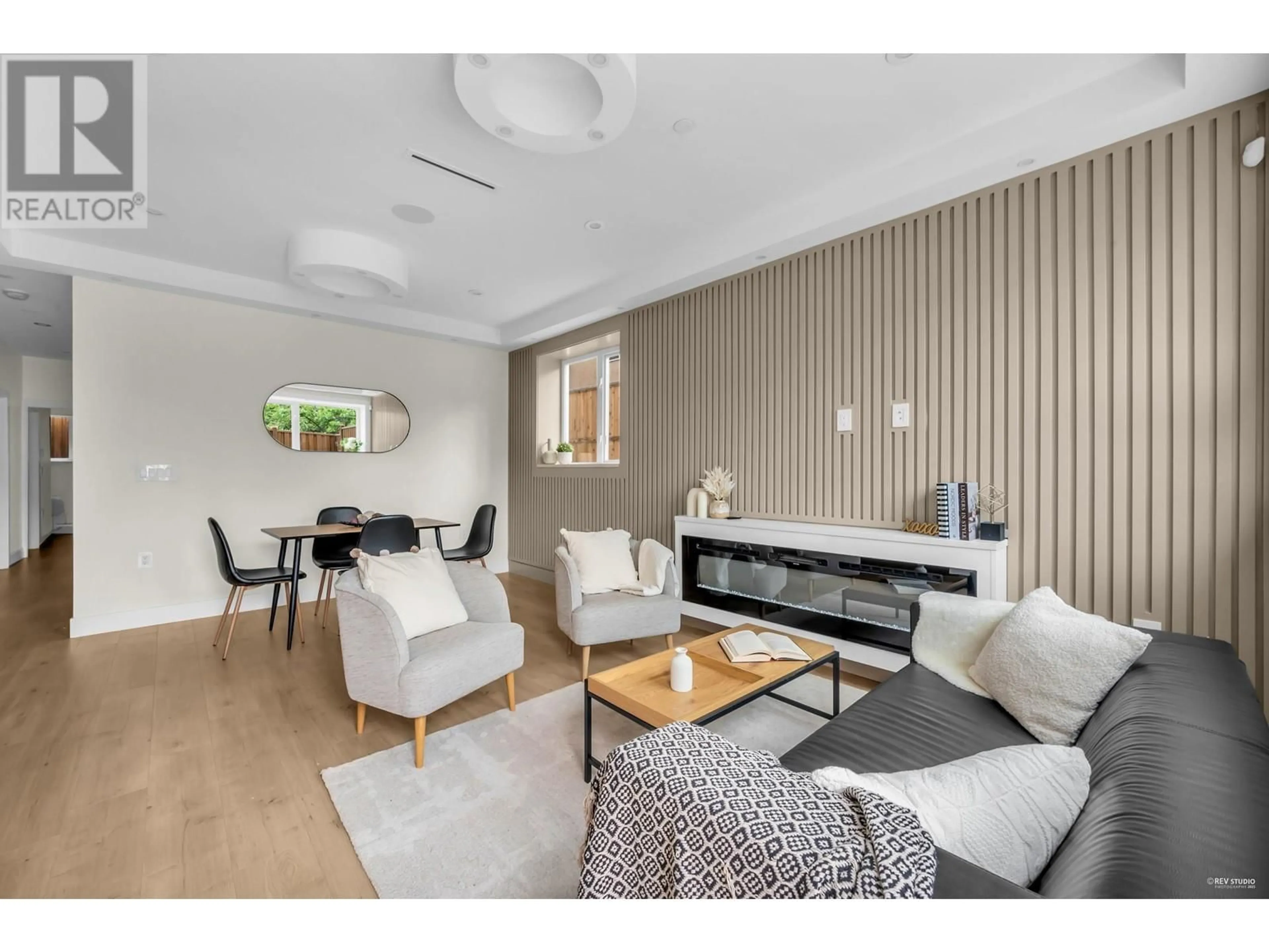 Living room with furniture, wood/laminate floor for 1 - 2512 E 22 AVENUE, Vancouver British Columbia V5M2X5