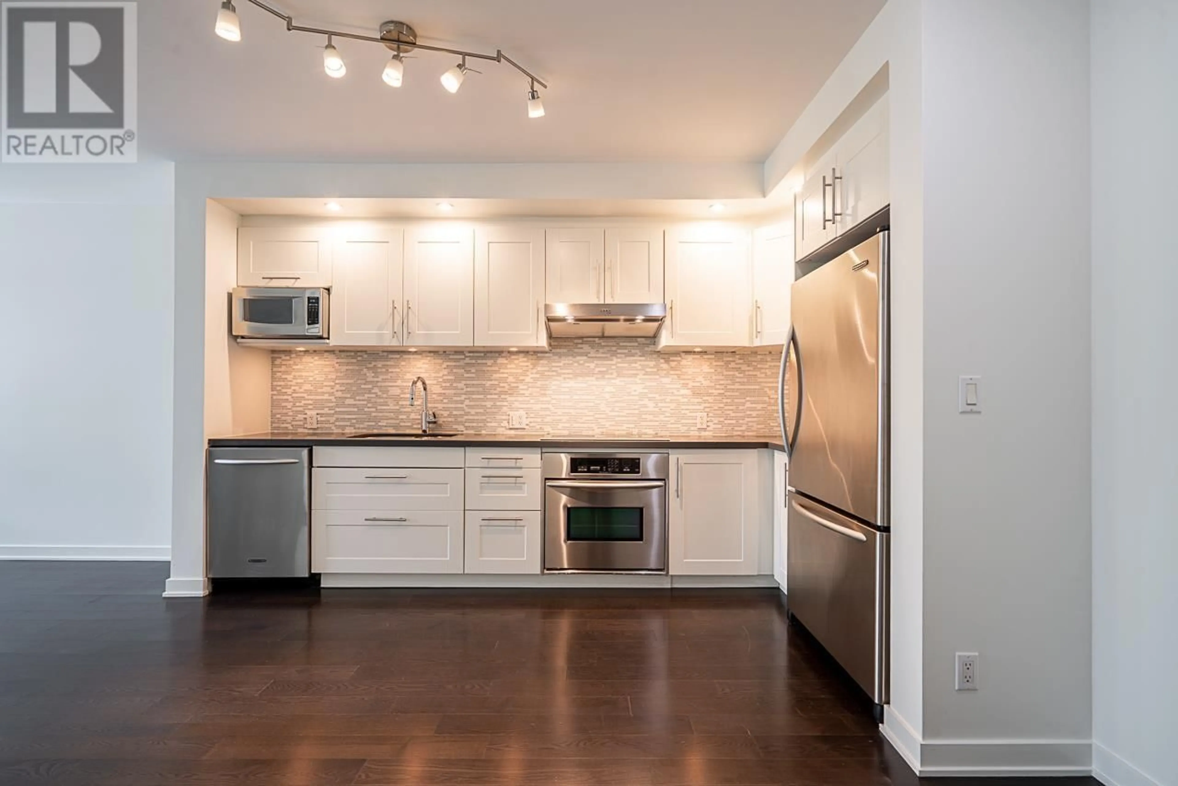 Open concept kitchen, wood/laminate floor for 310 - 750 12TH AVENUE, Vancouver British Columbia V5Z0A3