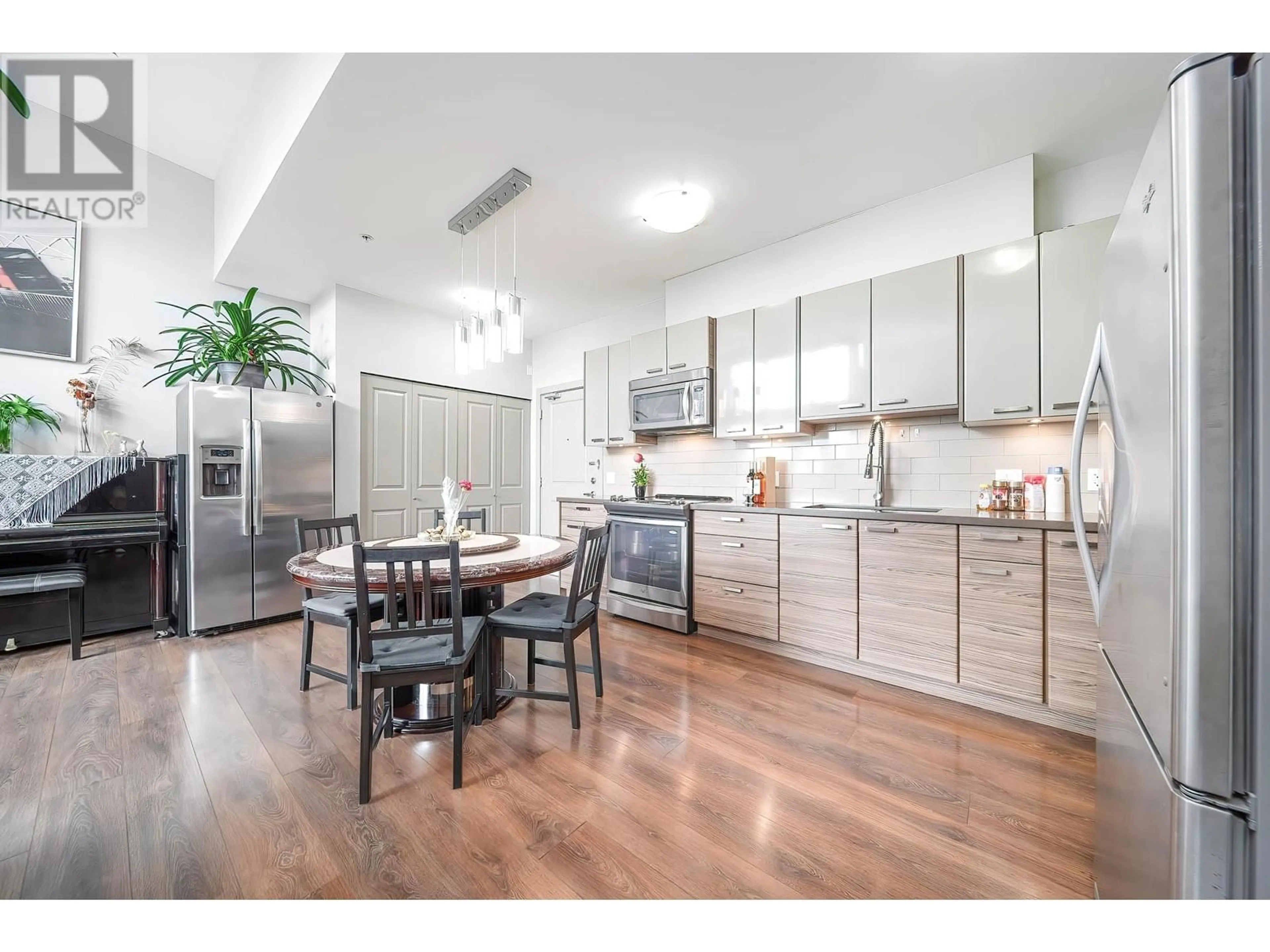 Open concept kitchen, wood/laminate floor for 401 - 6875 DUNBLANE AVENUE, Burnaby British Columbia V5J0G6