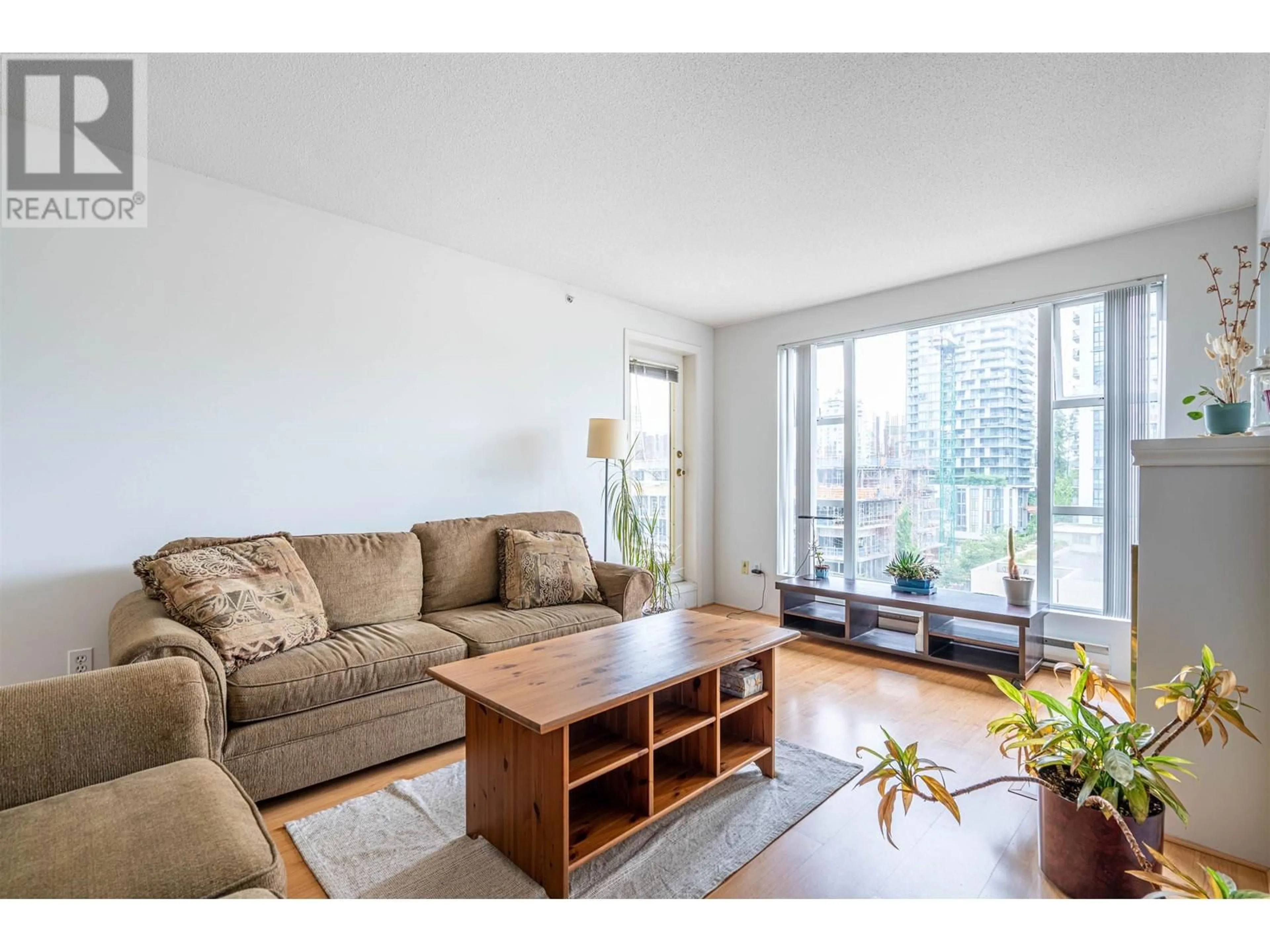 Living room with furniture, wood/laminate floor for 603 - 1180 PINETREE WAY, Coquitlam British Columbia V3B7L2