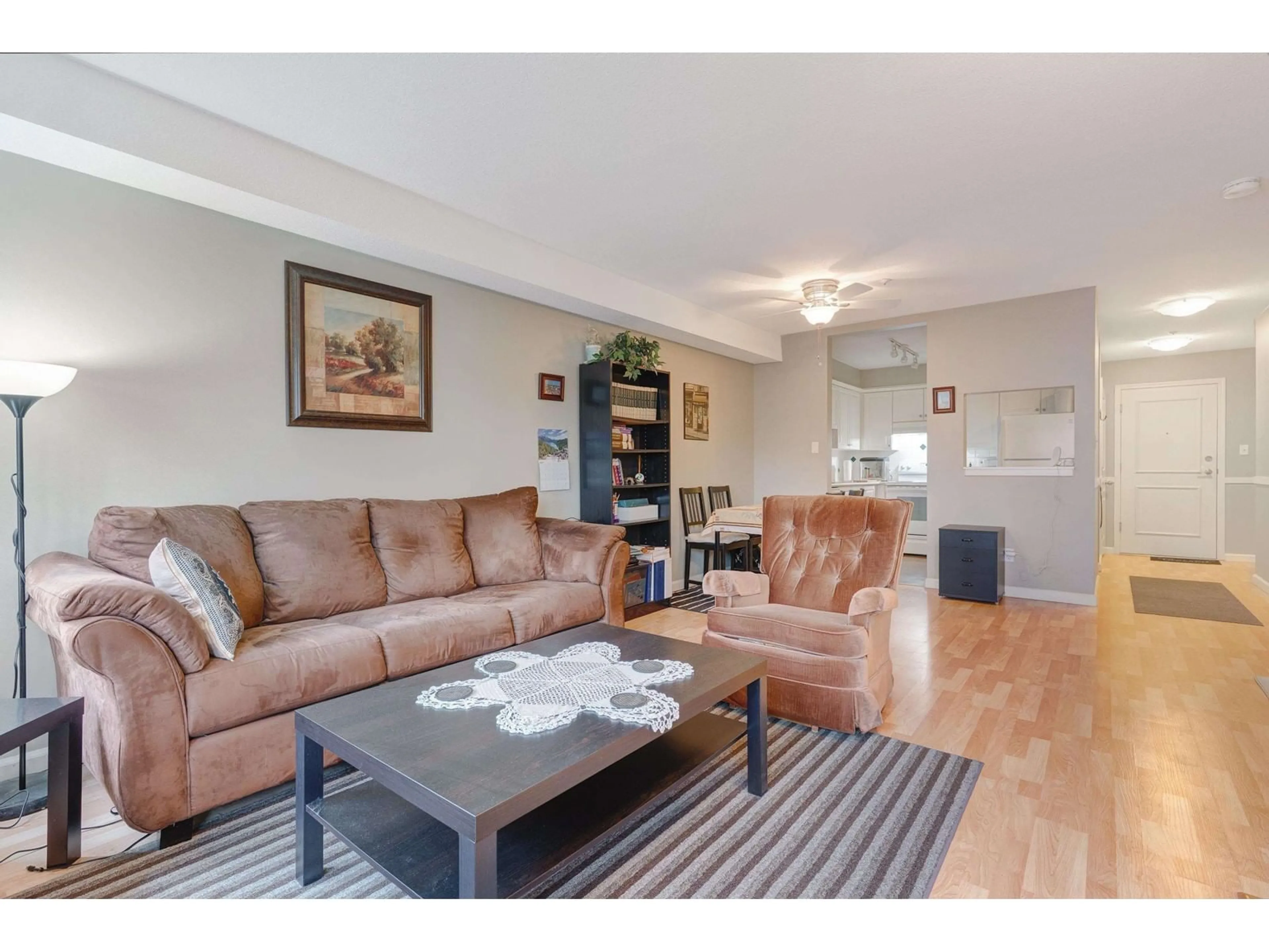 Living room with furniture, wood/laminate floor for 217 - 8139 121A, Surrey British Columbia V3W0Z2