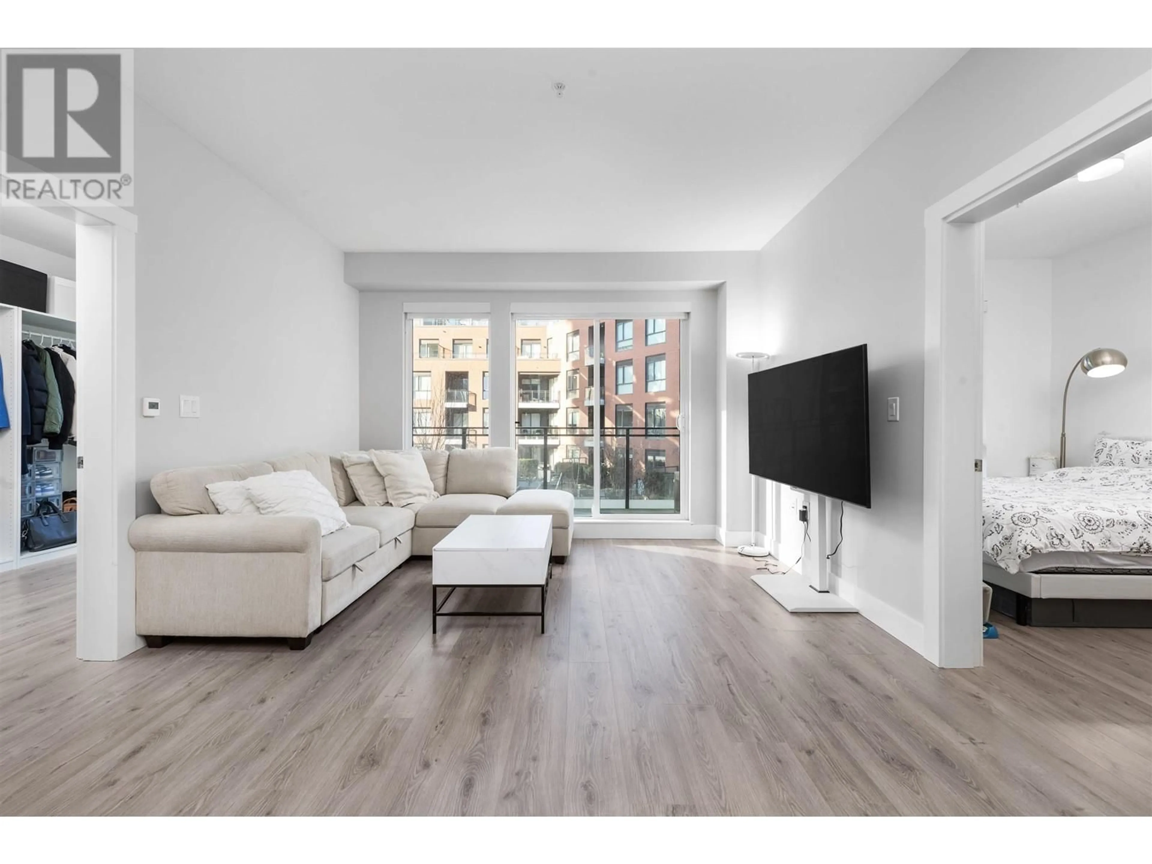 Living room with furniture, wood/laminate floor for 309 - 3588 SAWMILL CRESCENT, Vancouver British Columbia V5S0H5