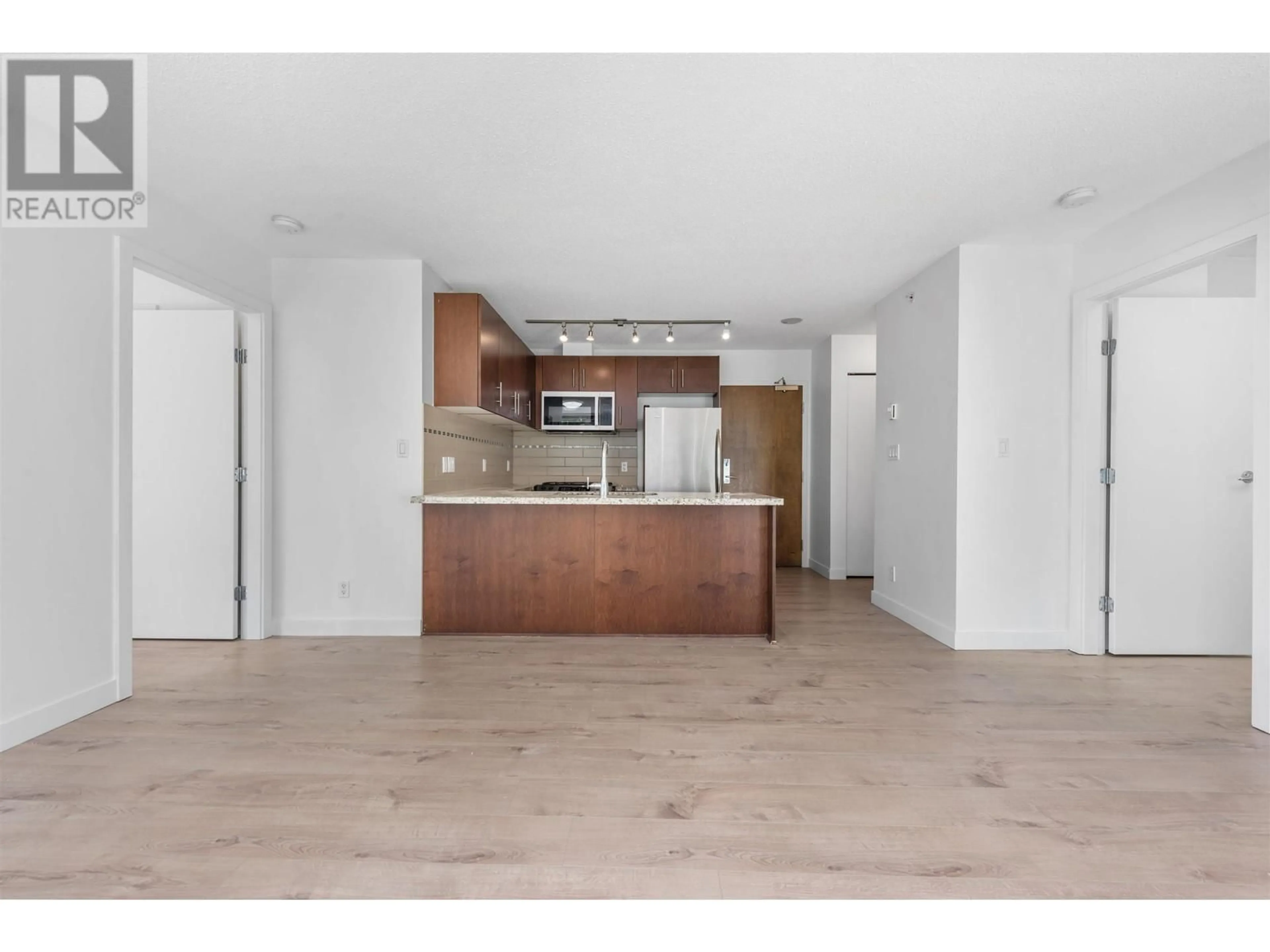 Open concept kitchen, wood/laminate floor for 511 - 8280 LANSDOWNE ROAD, Richmond British Columbia V6X0B2