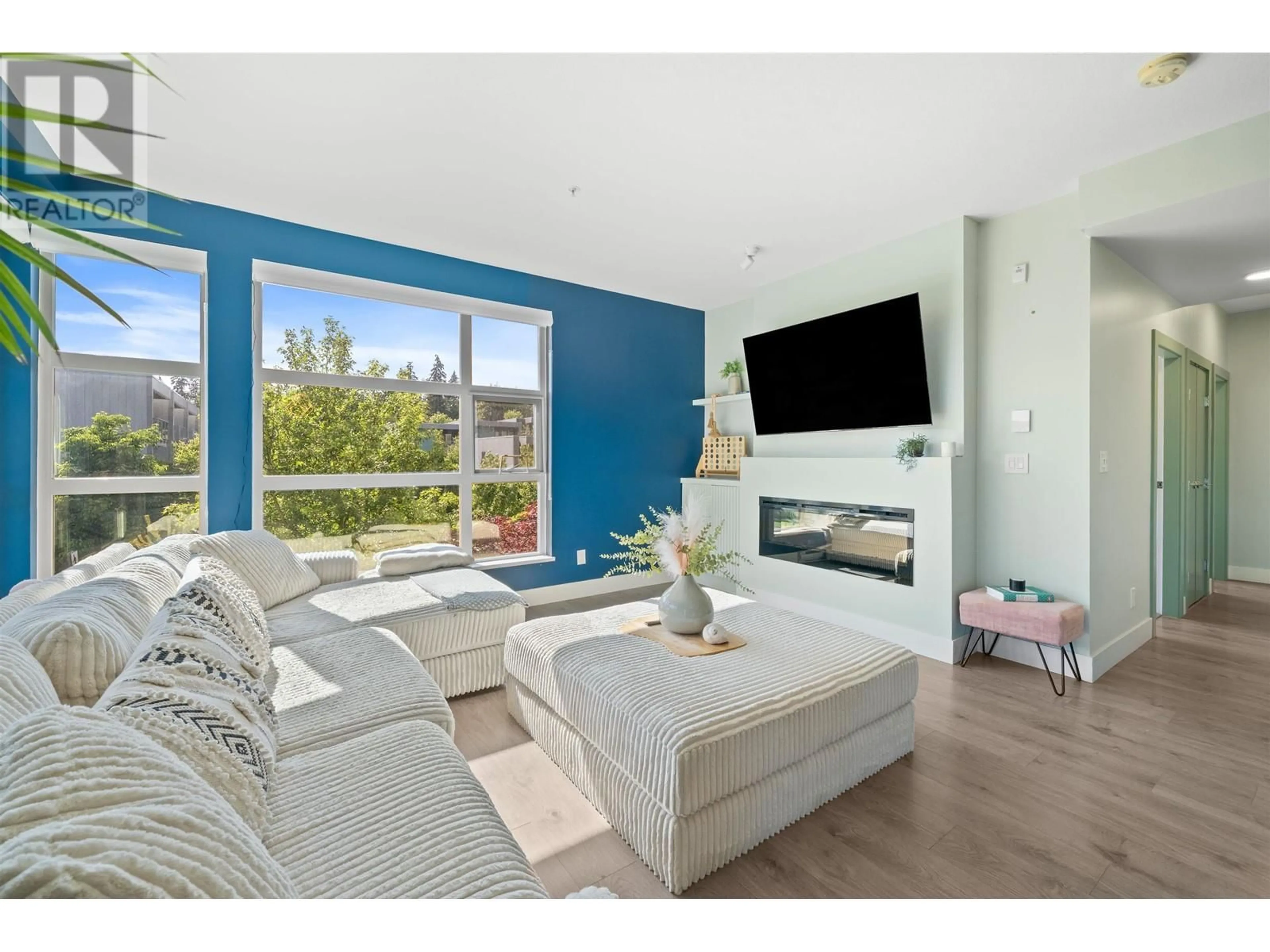Living room with furniture, wood/laminate floor for 202 - 3602 ALDERCREST DR DRIVE, North Vancouver British Columbia V7G0A2