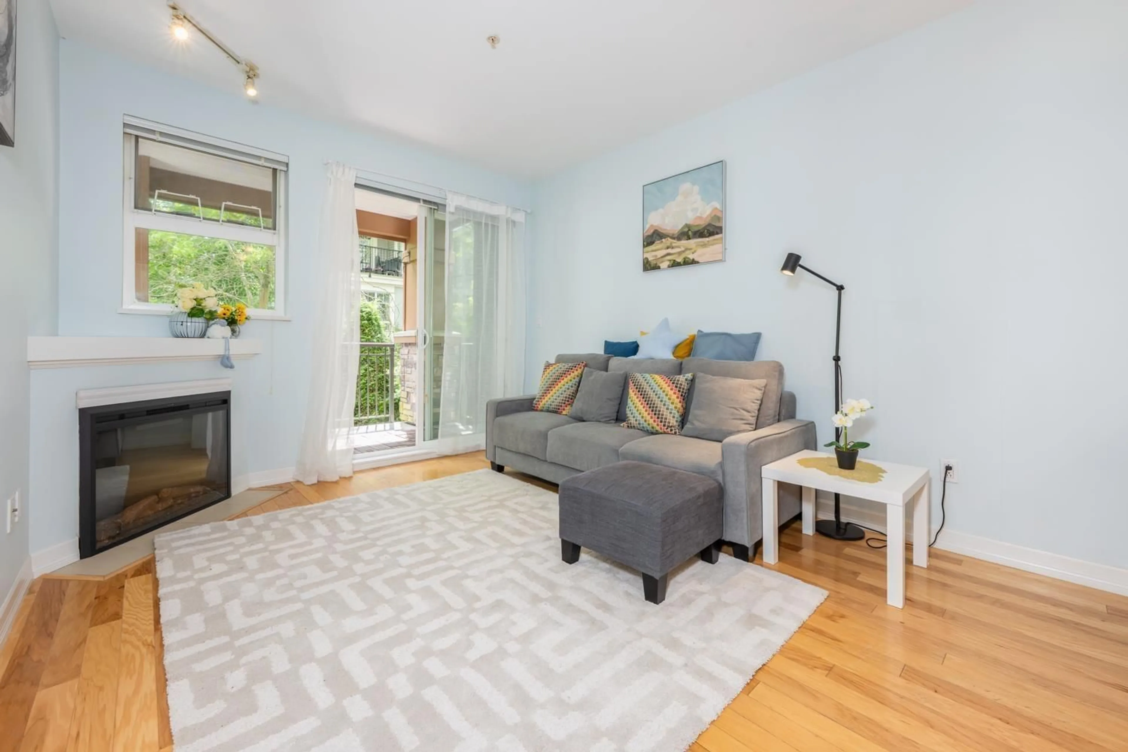 Living room with furniture, wood/laminate floor for 207 - 10237 133, Surrey British Columbia V3T0C6