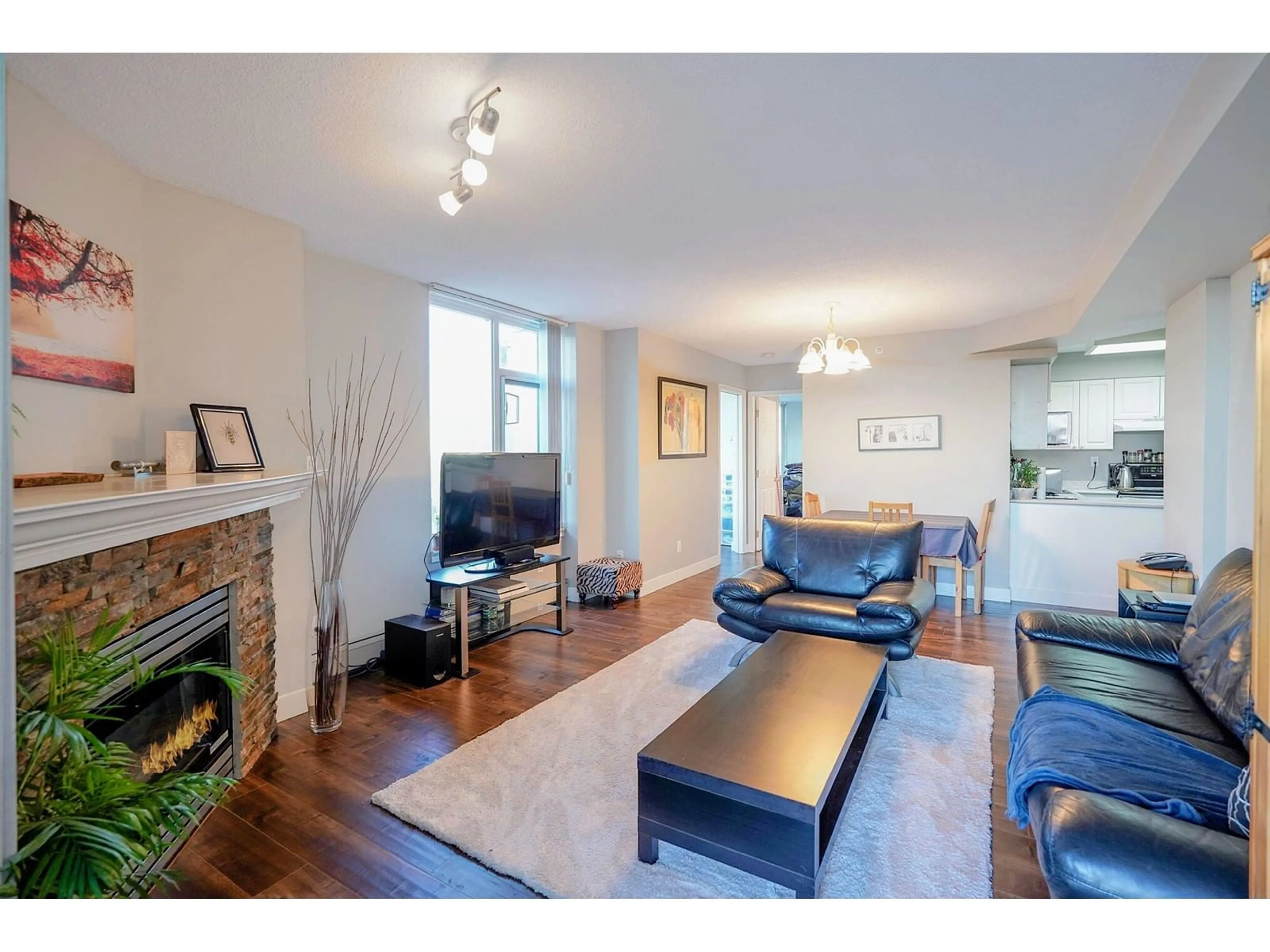 Living room with furniture, wood/laminate floor for 1106 - 13880 101, Surrey British Columbia V3T5T1