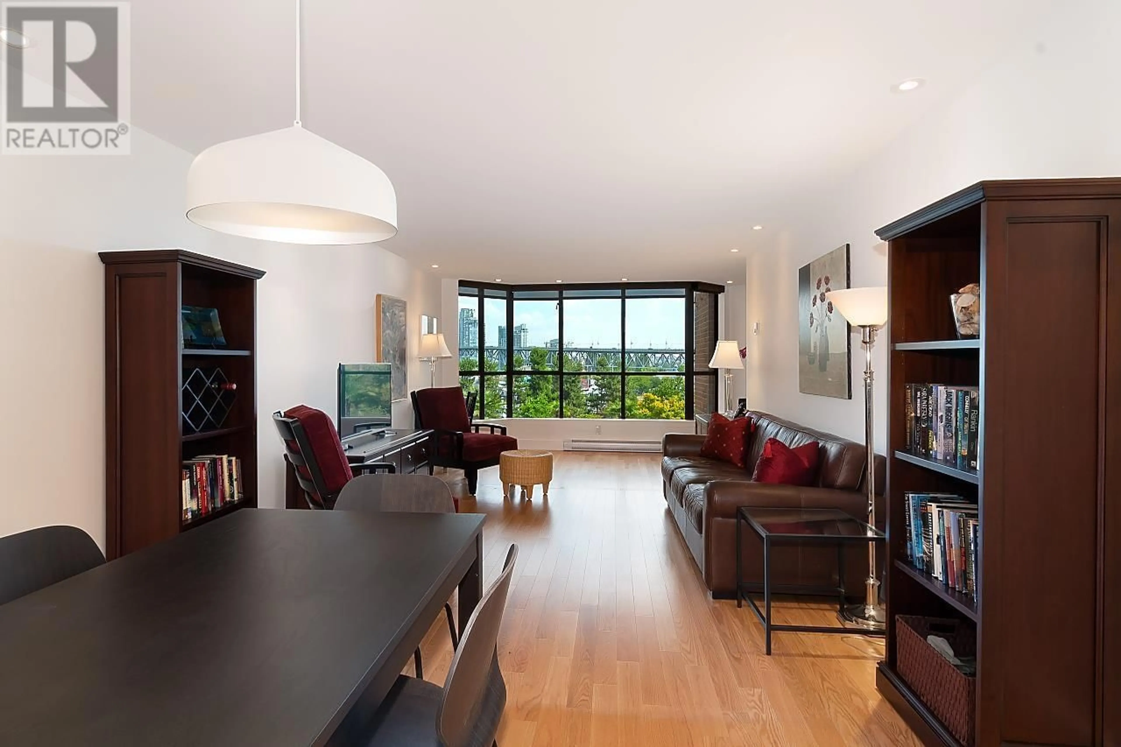 Living room with furniture, wood/laminate floor for 408 - 1470 PENNYFARTHING DRIVE, Vancouver British Columbia V6J4X8