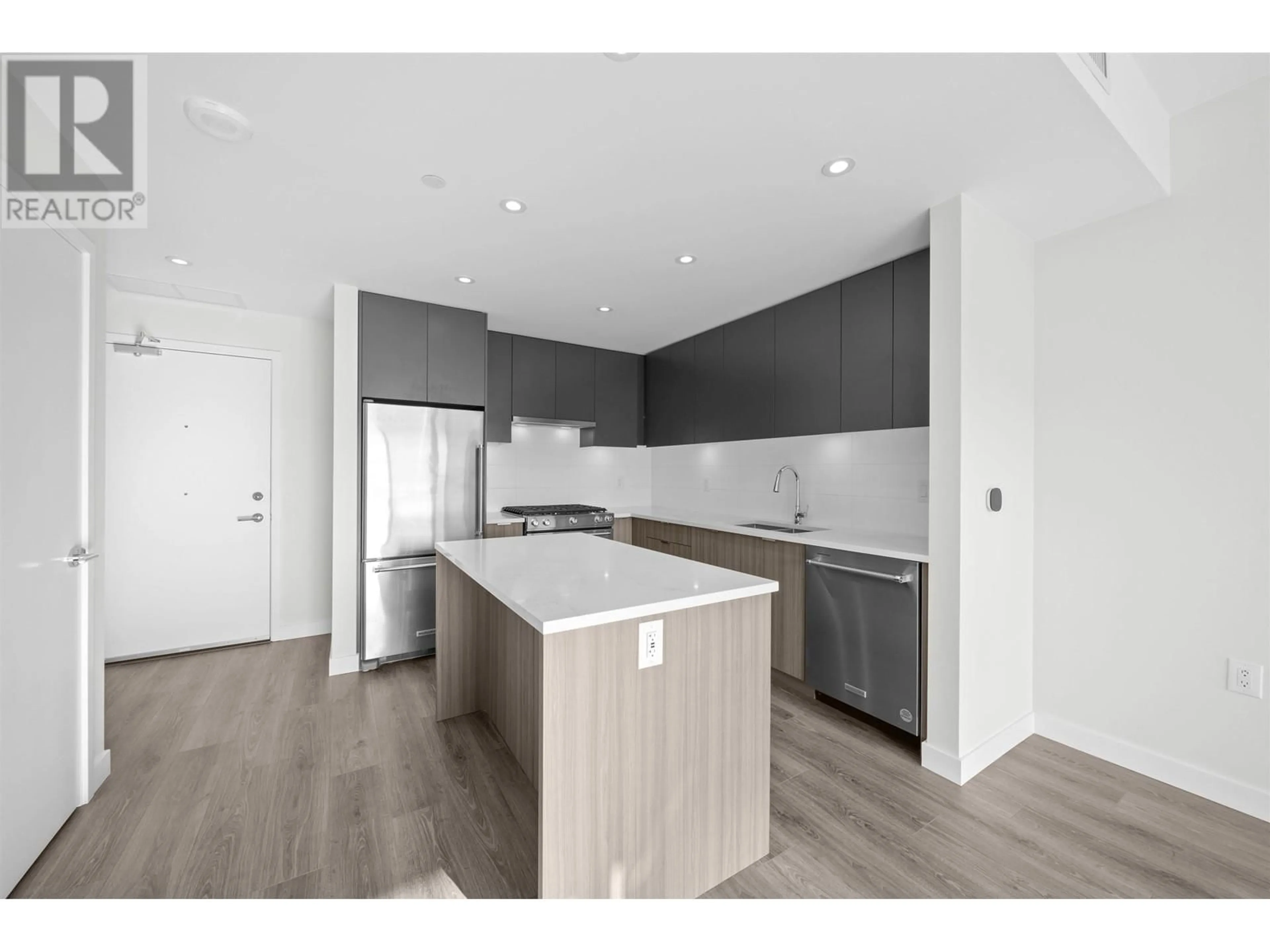 Open concept kitchen, wood/laminate floor for 312 - 3430 KENT AVENUE, Vancouver British Columbia V5S0G7