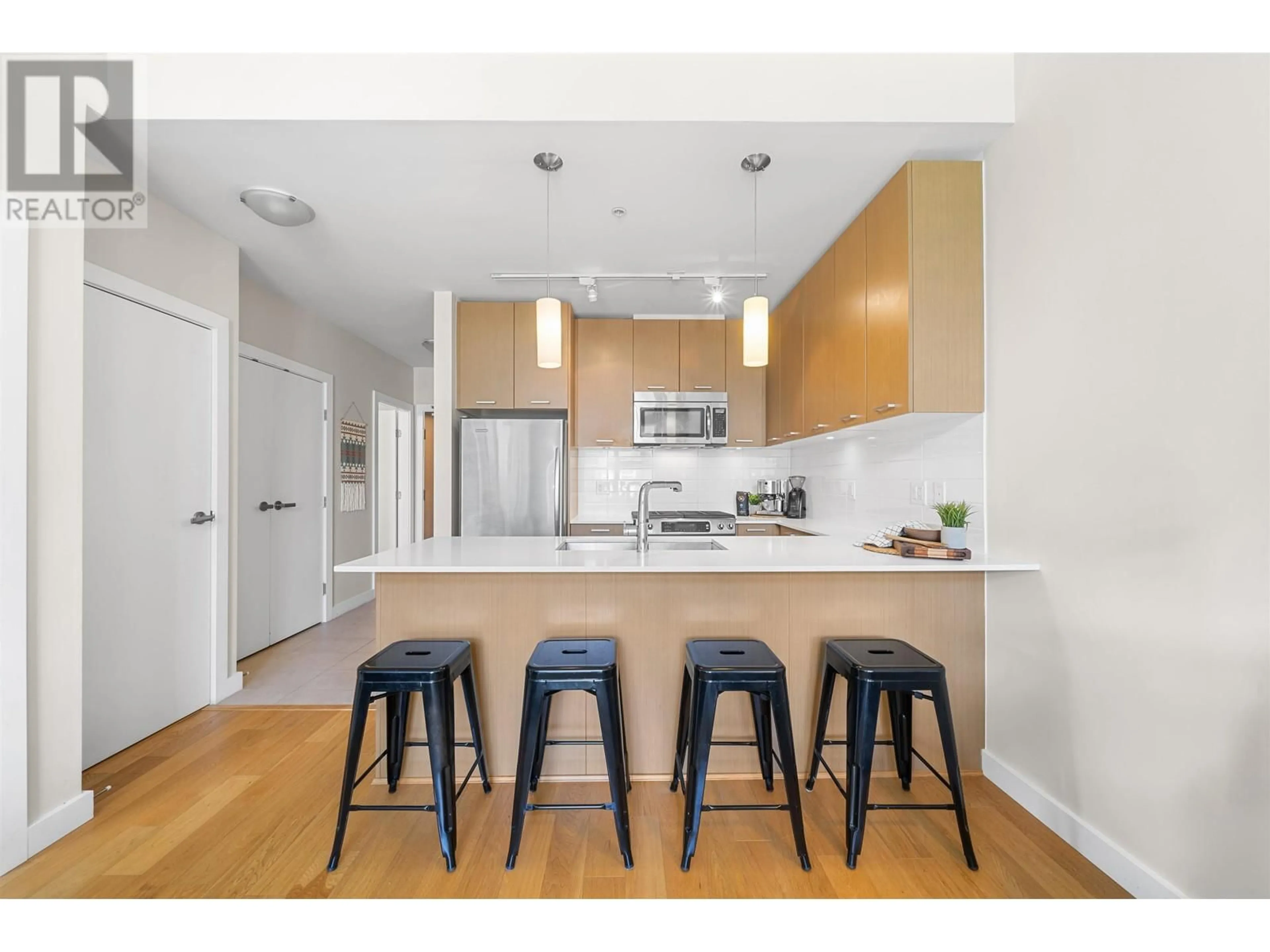 Open concept kitchen, wood/laminate floor for 402 - 1182 16TH STREET, North Vancouver British Columbia V7P0B3