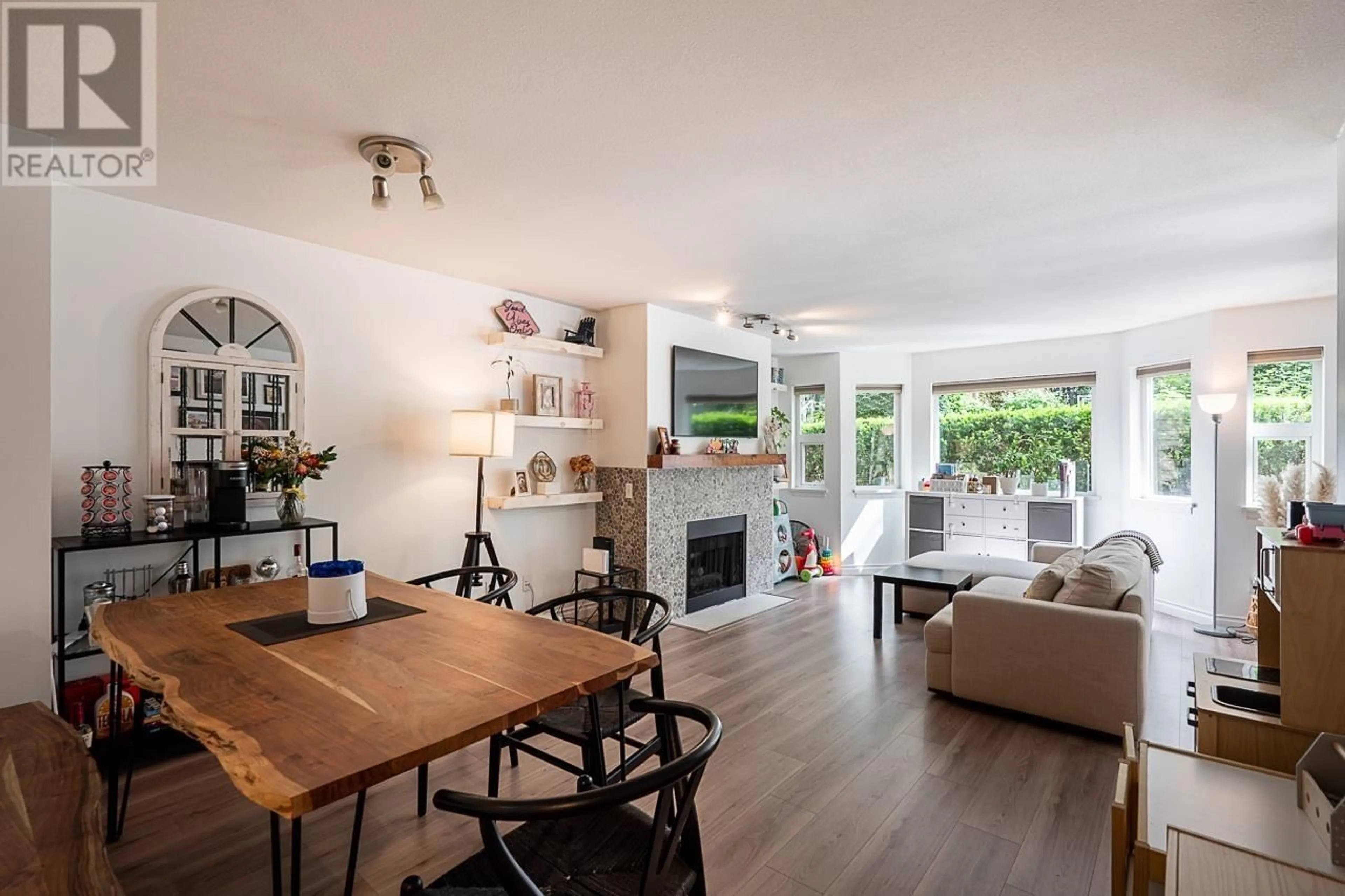 Living room with furniture, wood/laminate floor for 223 - 6707 SOUTHPOINT DRIVE, Burnaby British Columbia V3N4V8