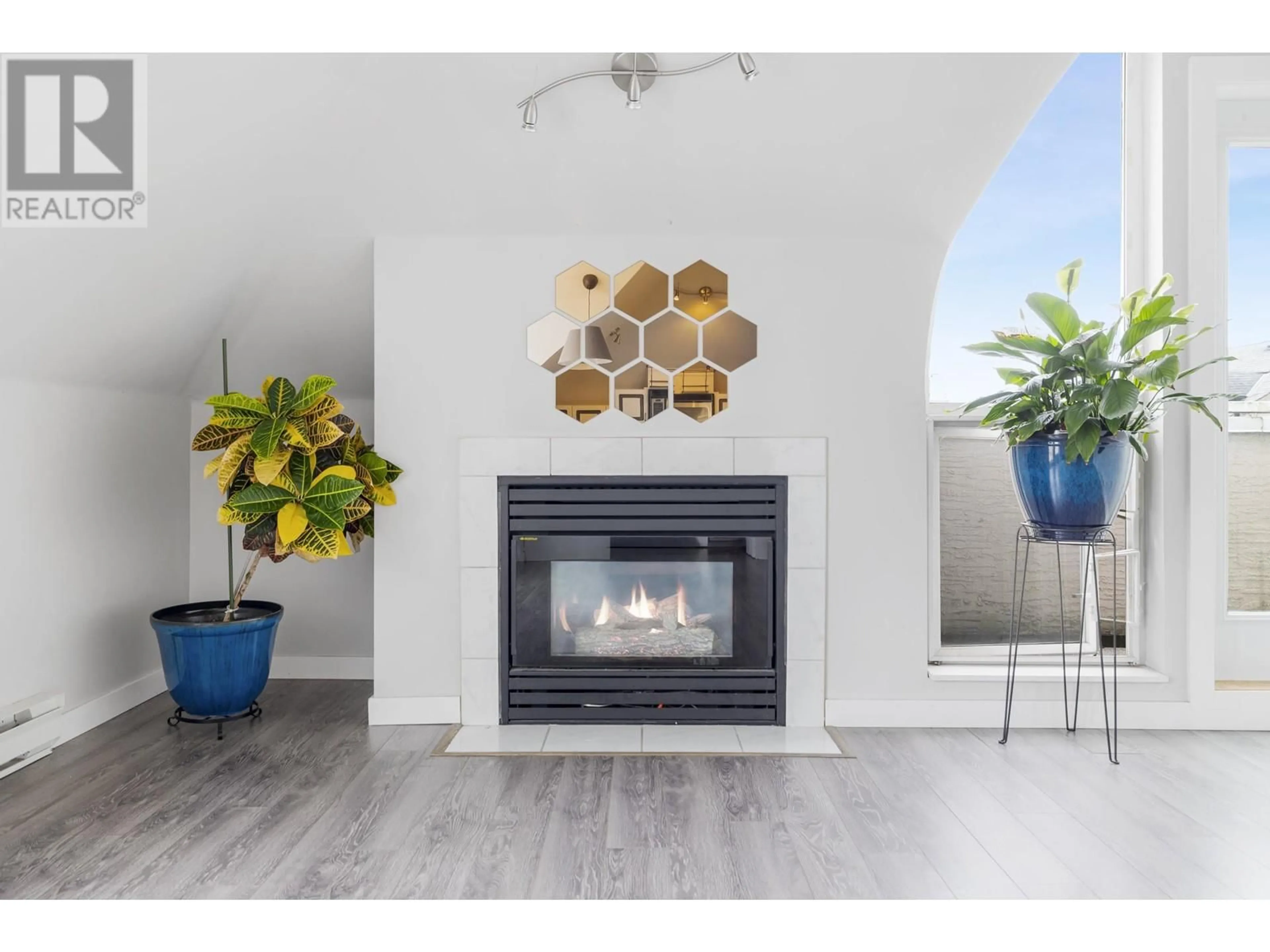 Living room with furniture, wood/laminate floor for 404 - 1570 PRAIRIE AVENUE, Port Coquitlam British Columbia V3B1T4