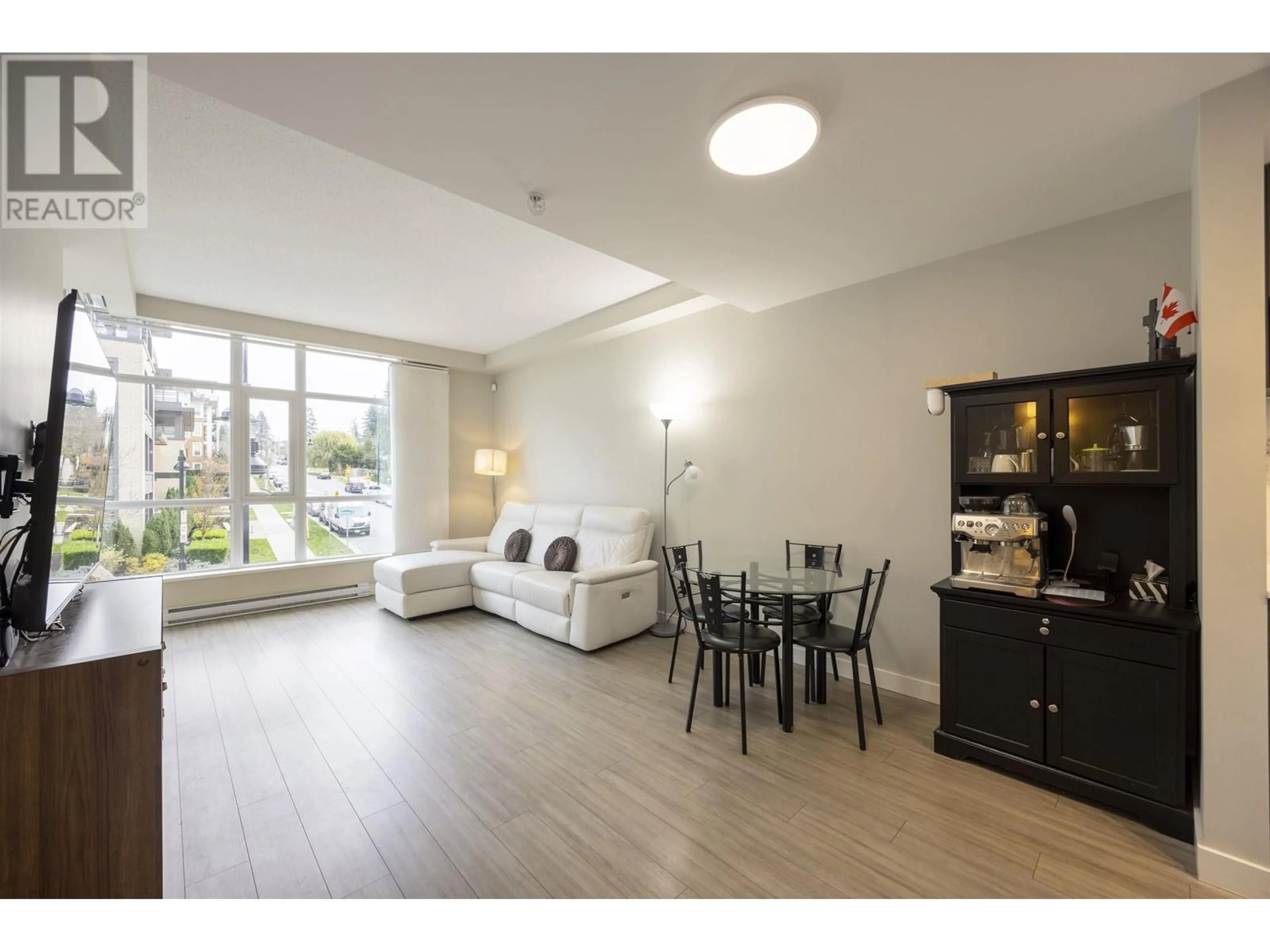 Living room with furniture, wood/laminate floor for 102 - 578 EMERSON STREET, Coquitlam British Columbia V3J0G4