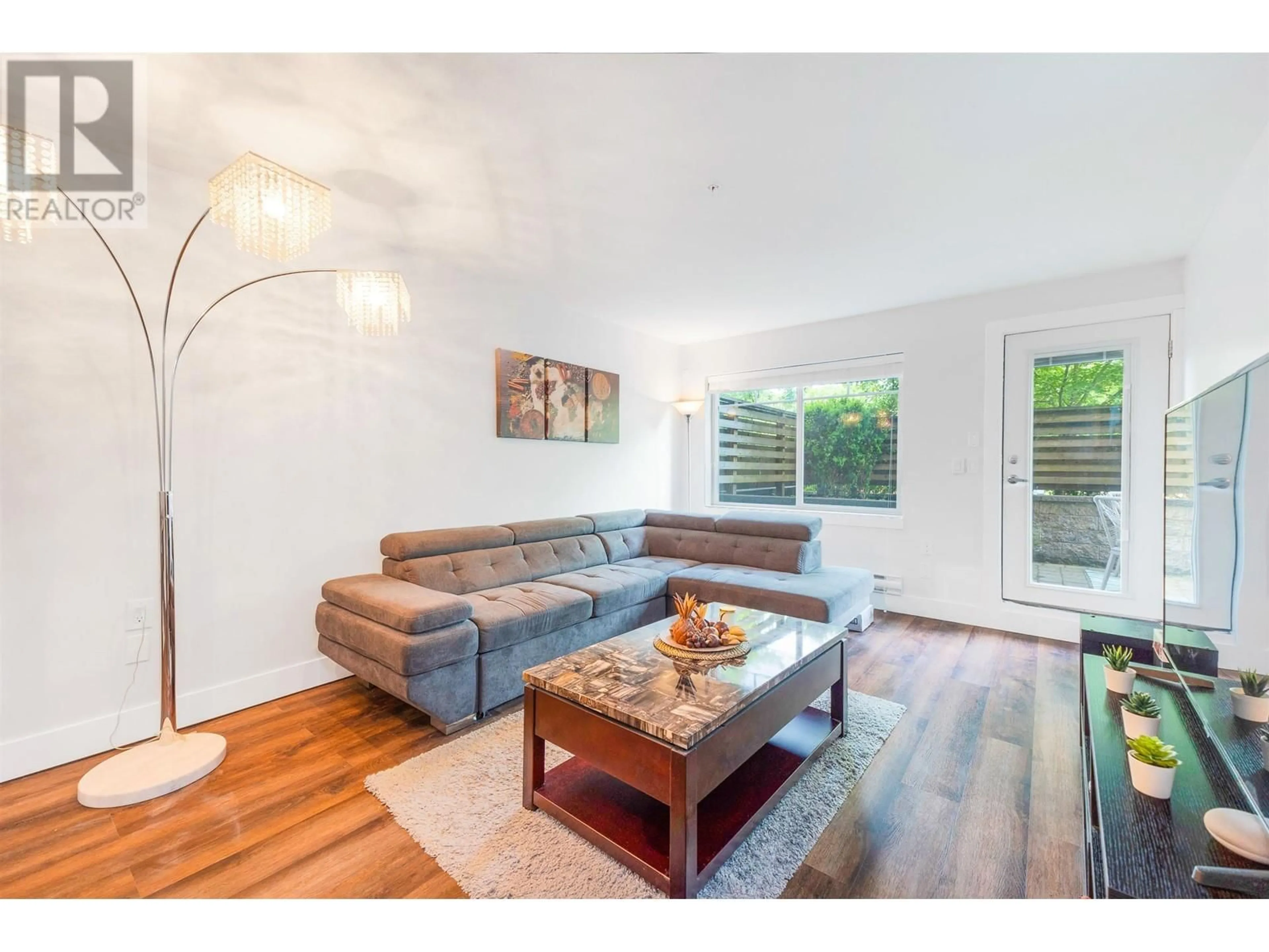 Living room with furniture, wood/laminate floor for 104 - 1990 WESTMINSTER AVENUE, Port Coquitlam British Columbia V3B1E8