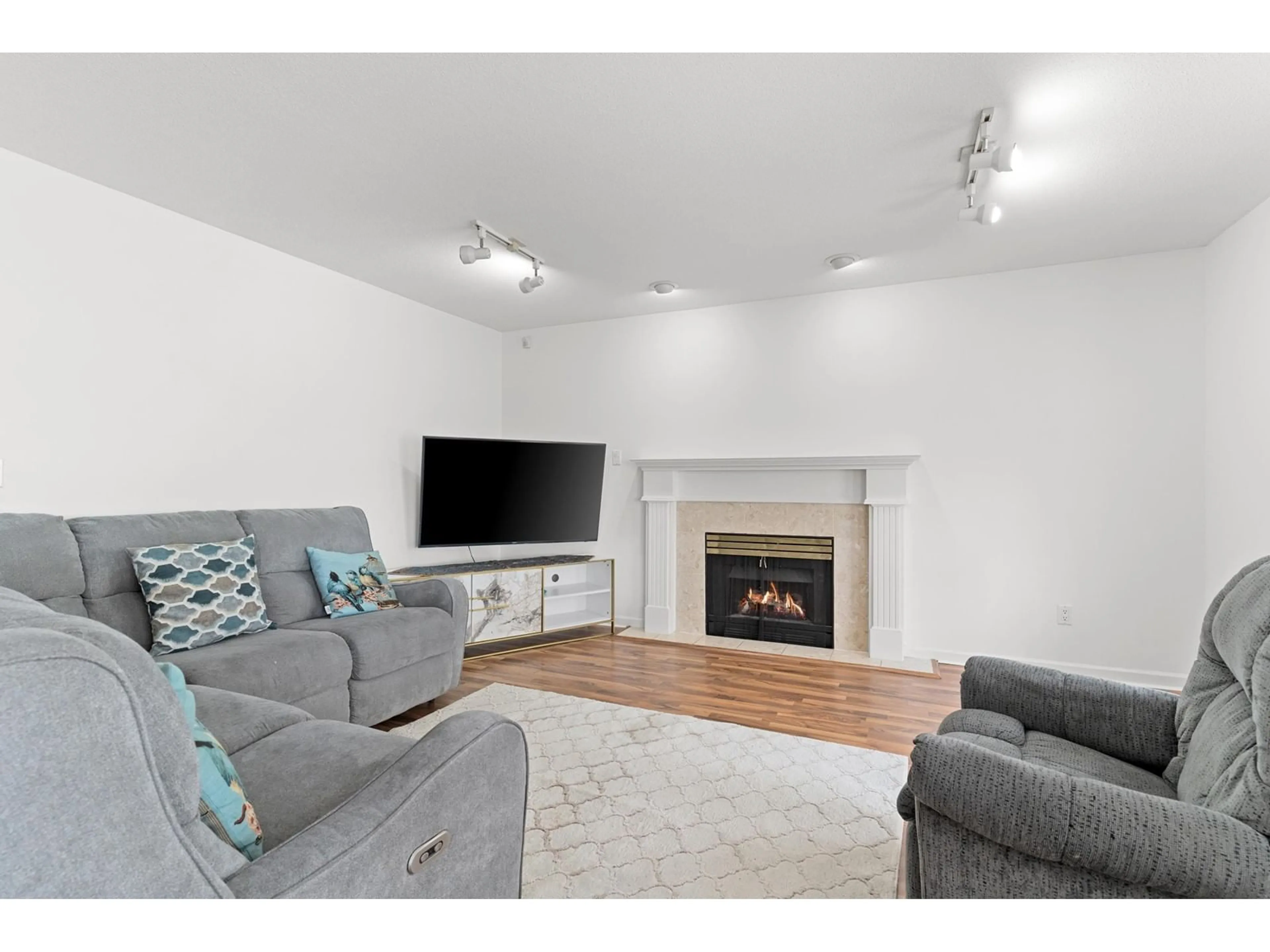 Living room with furniture, wood/laminate floor for 8201 NECHAKO, Delta British Columbia V4C3X2