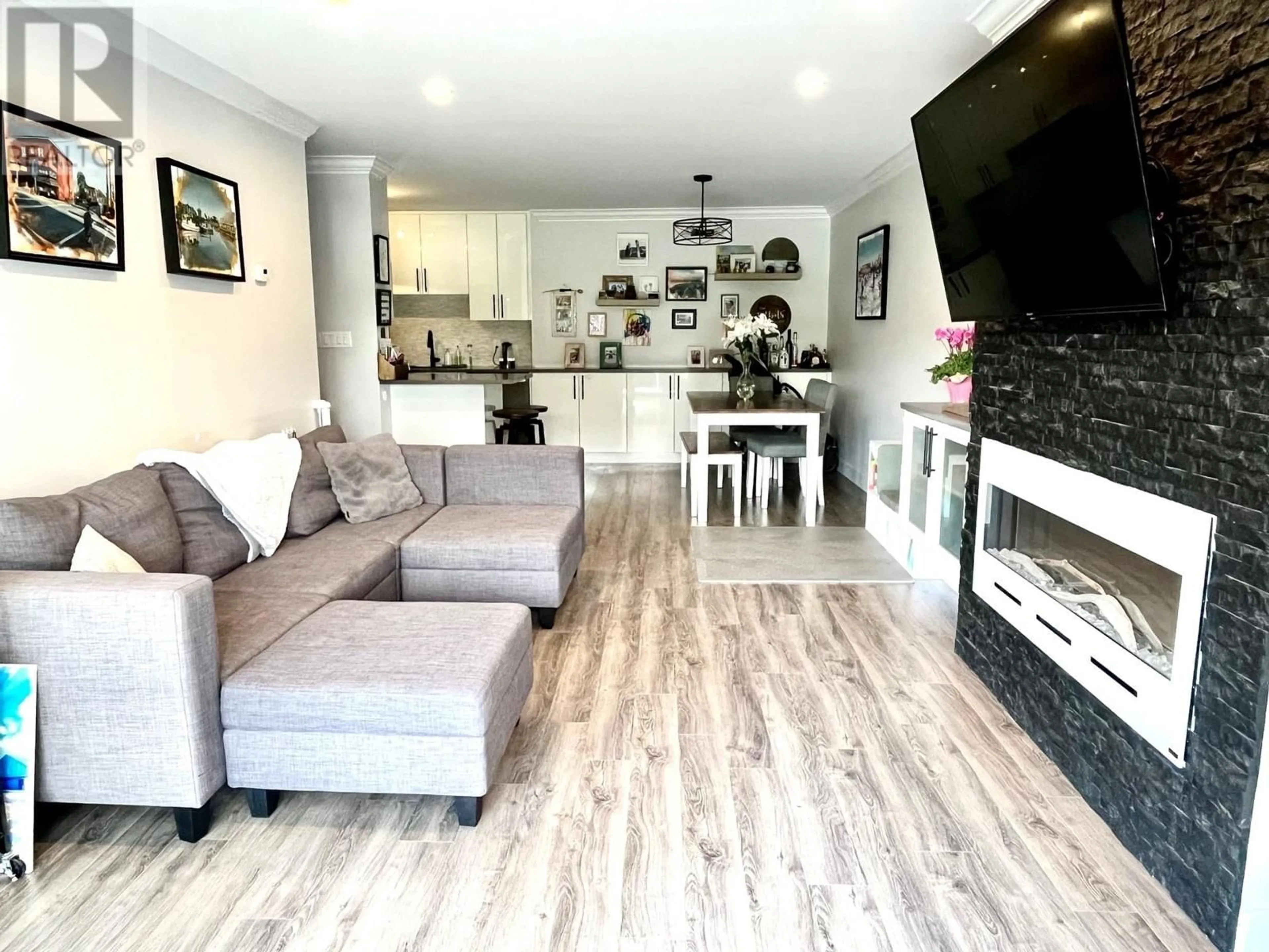 Living room with furniture, wood/laminate floor for 103 - 8740 NO. 1 ROAD, Richmond British Columbia V7C4L5