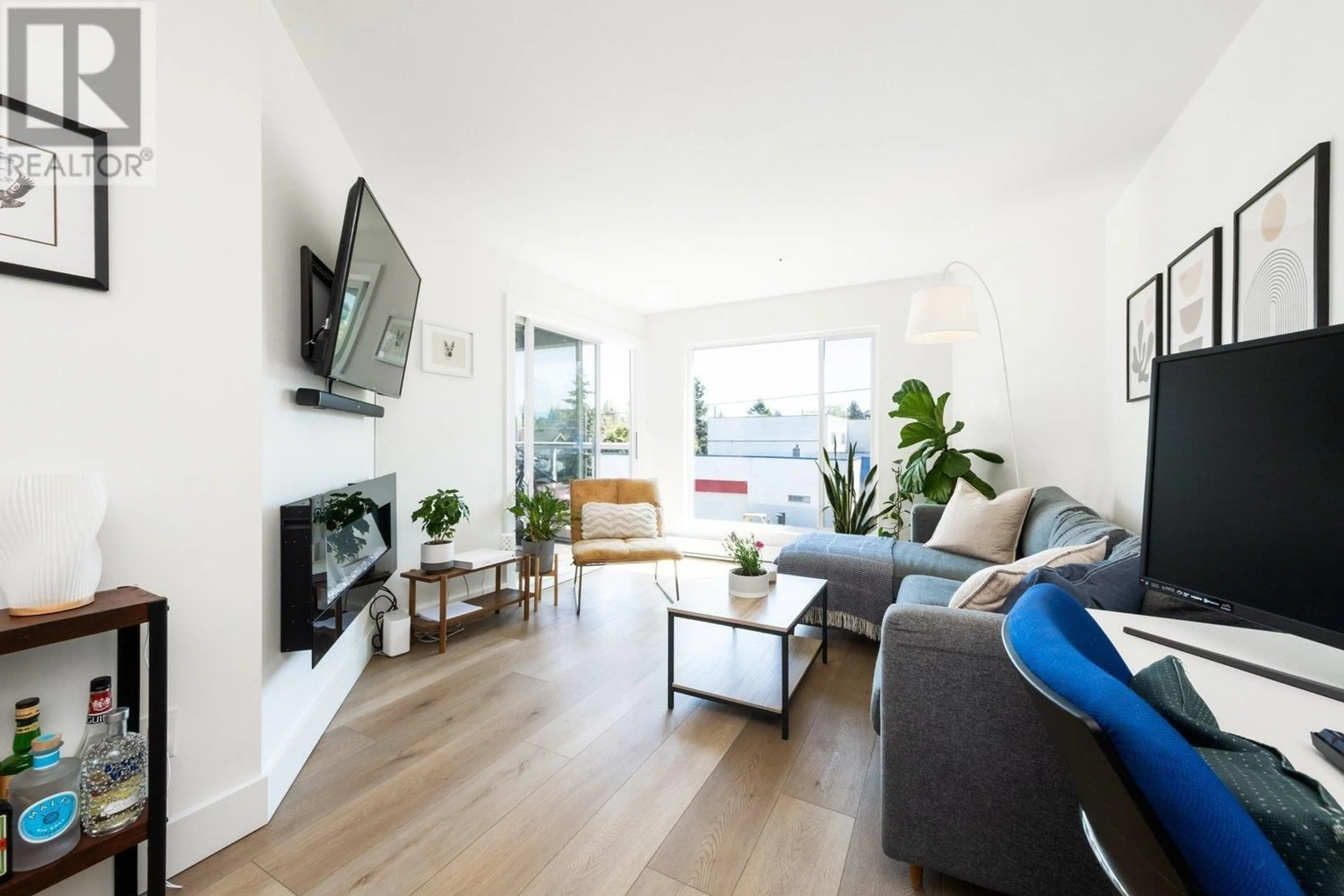 Living room with furniture, wood/laminate floor for 302 - 3505 BROADWAY, Vancouver British Columbia V6R2B5