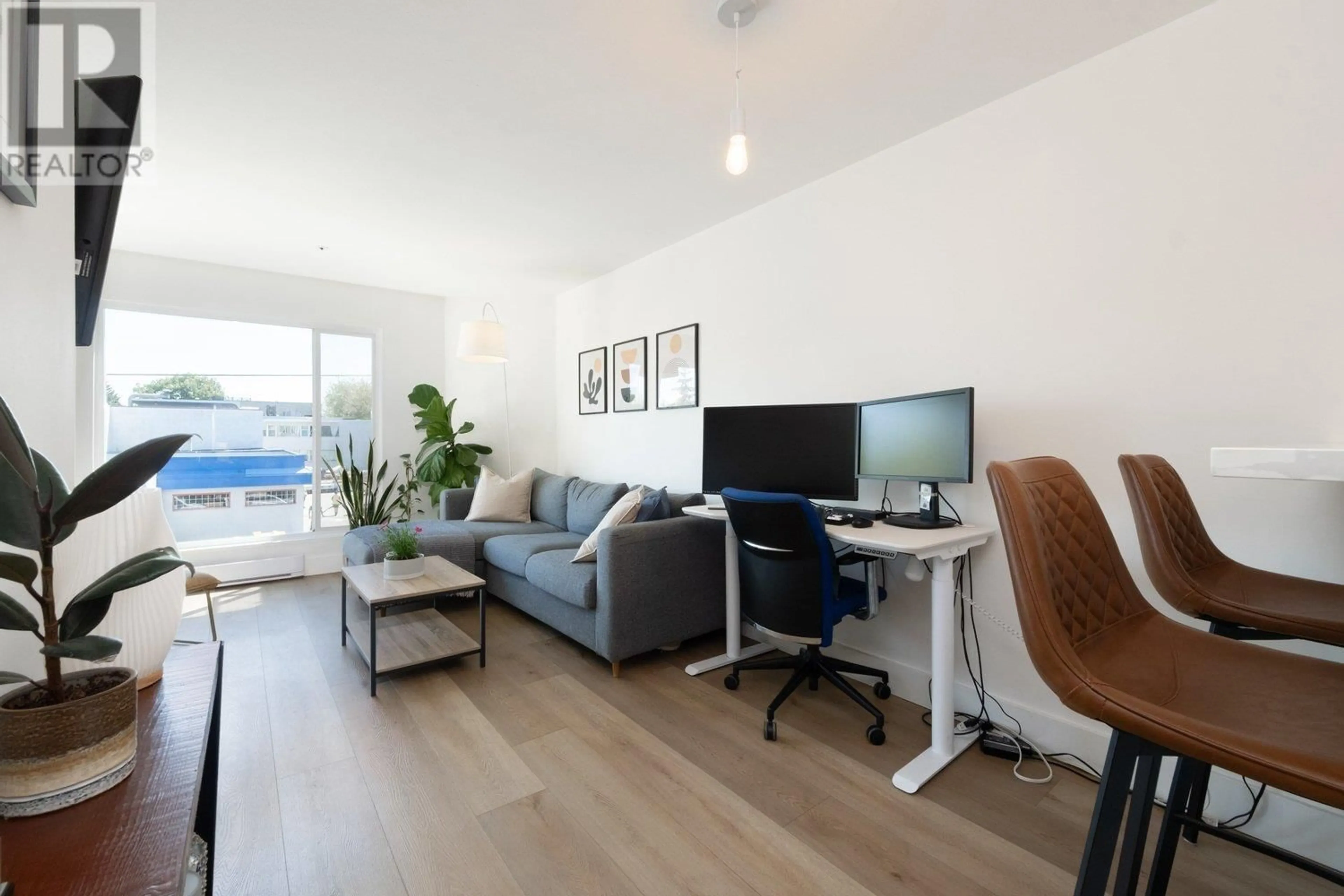 Living room with furniture, wood/laminate floor for 302 - 3505 BROADWAY, Vancouver British Columbia V6R2B5