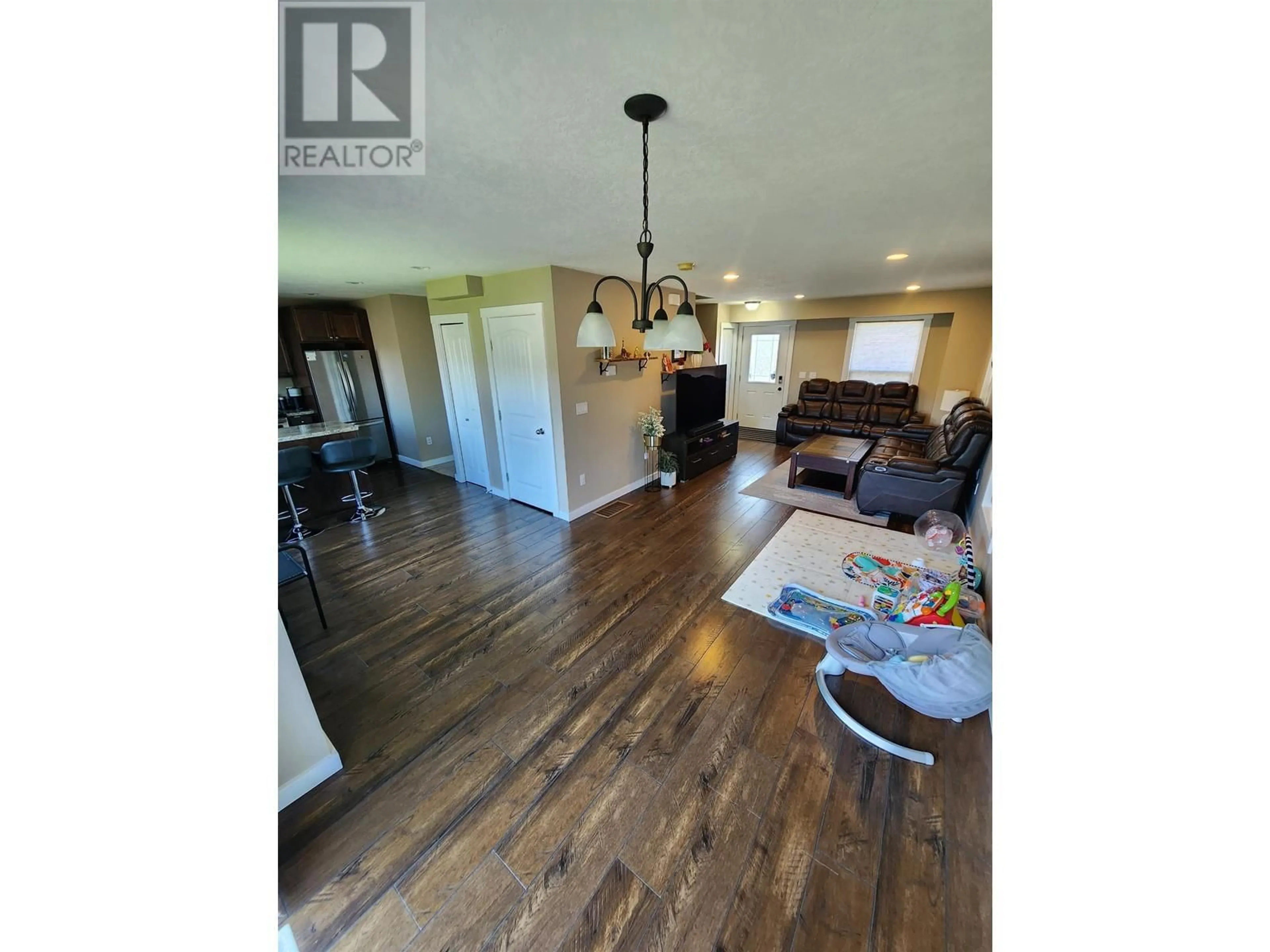 Open concept kitchen, wood/laminate floor for 7926 87 AVENUE, Fort St. John British Columbia V1J0M4