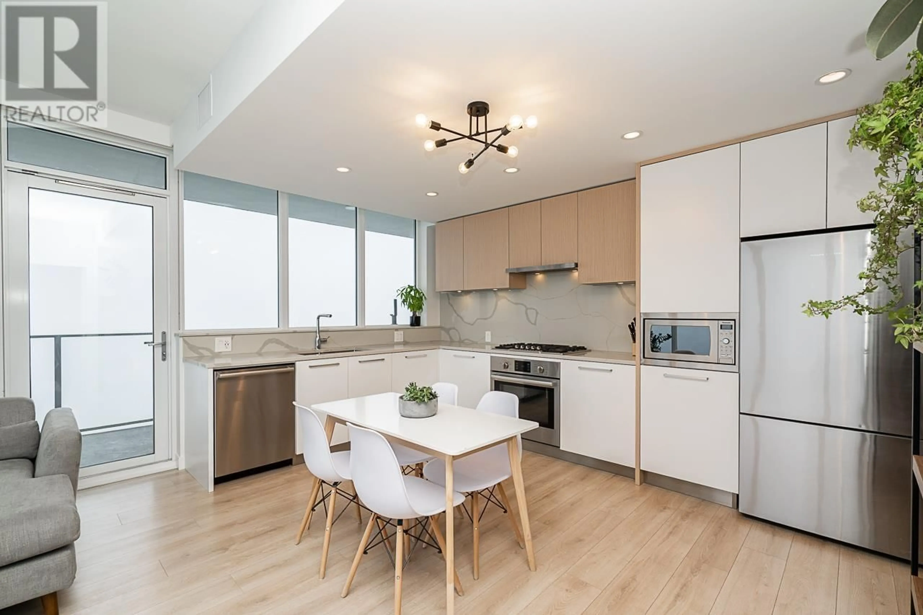 Open concept kitchen, wood/laminate floor for 2704 - 567 CLARKE ROAD, Coquitlam British Columbia V3J0K7