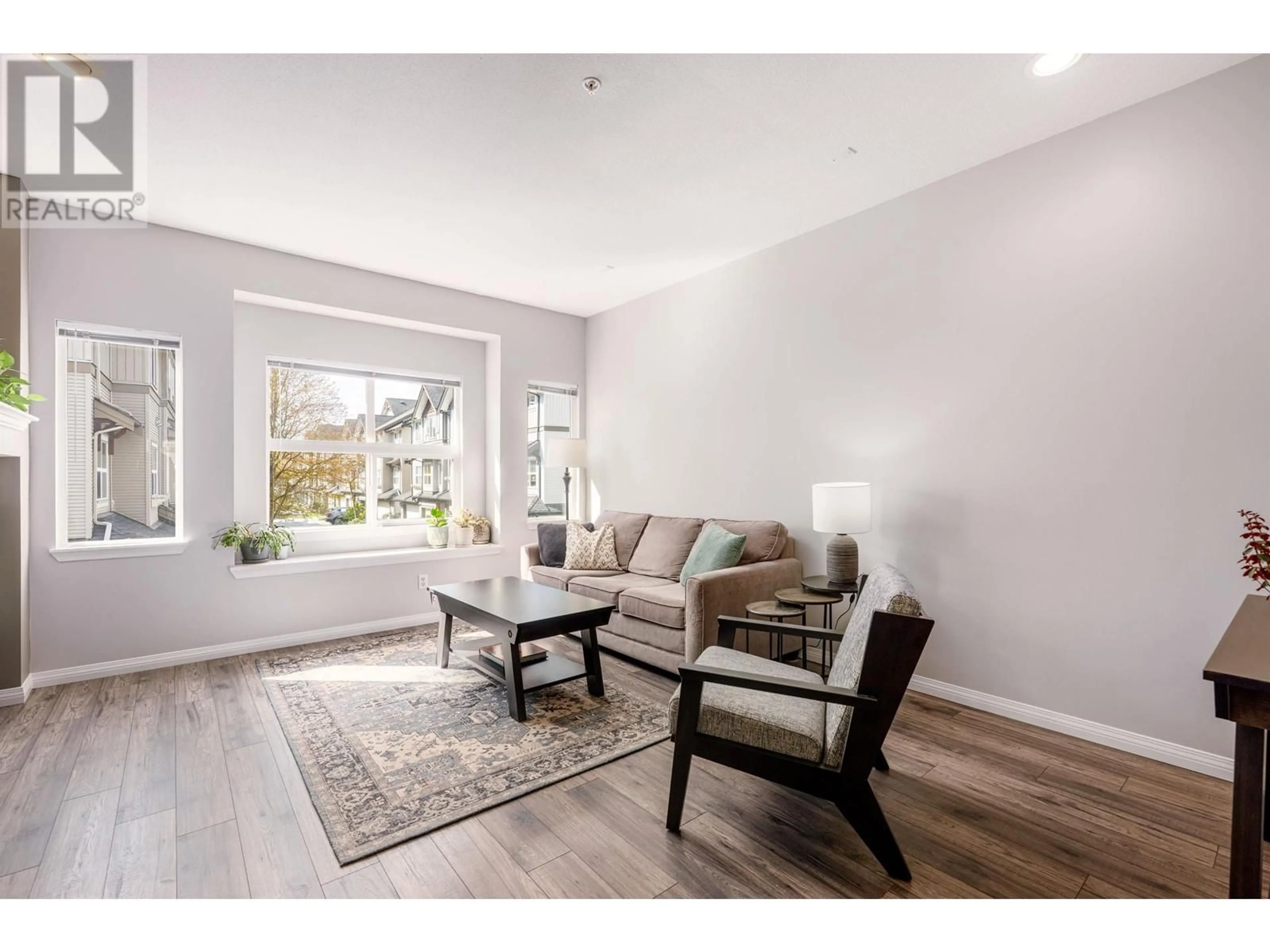 Living room with furniture, wood/laminate floor for 111 - 1055 RIVERWOOD GATE, Port Coquitlam British Columbia V3B8C3