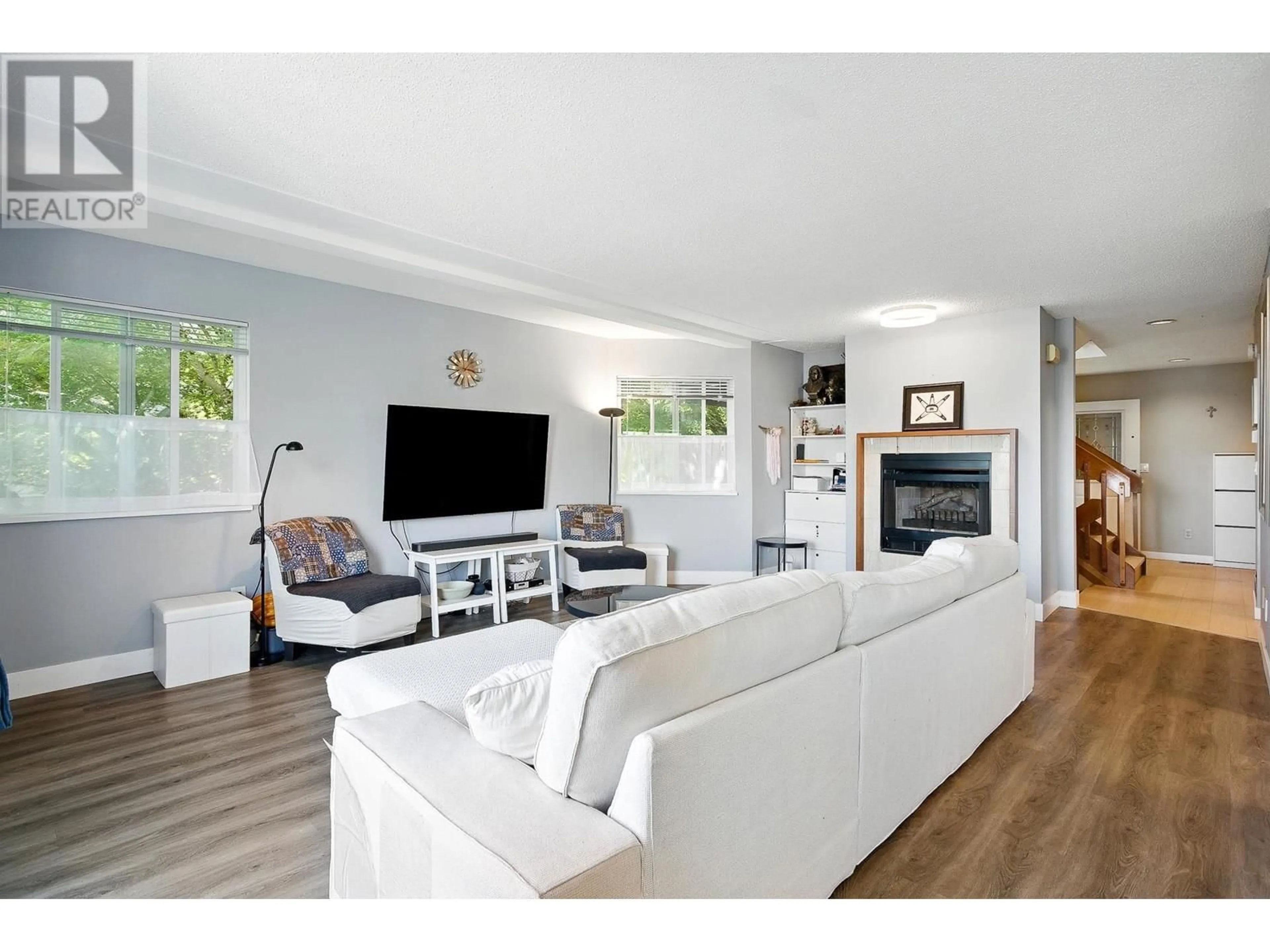 Living room with furniture, wood/laminate floor for 134 - 2721 ATLIN PLACE, Coquitlam British Columbia V3C5B1