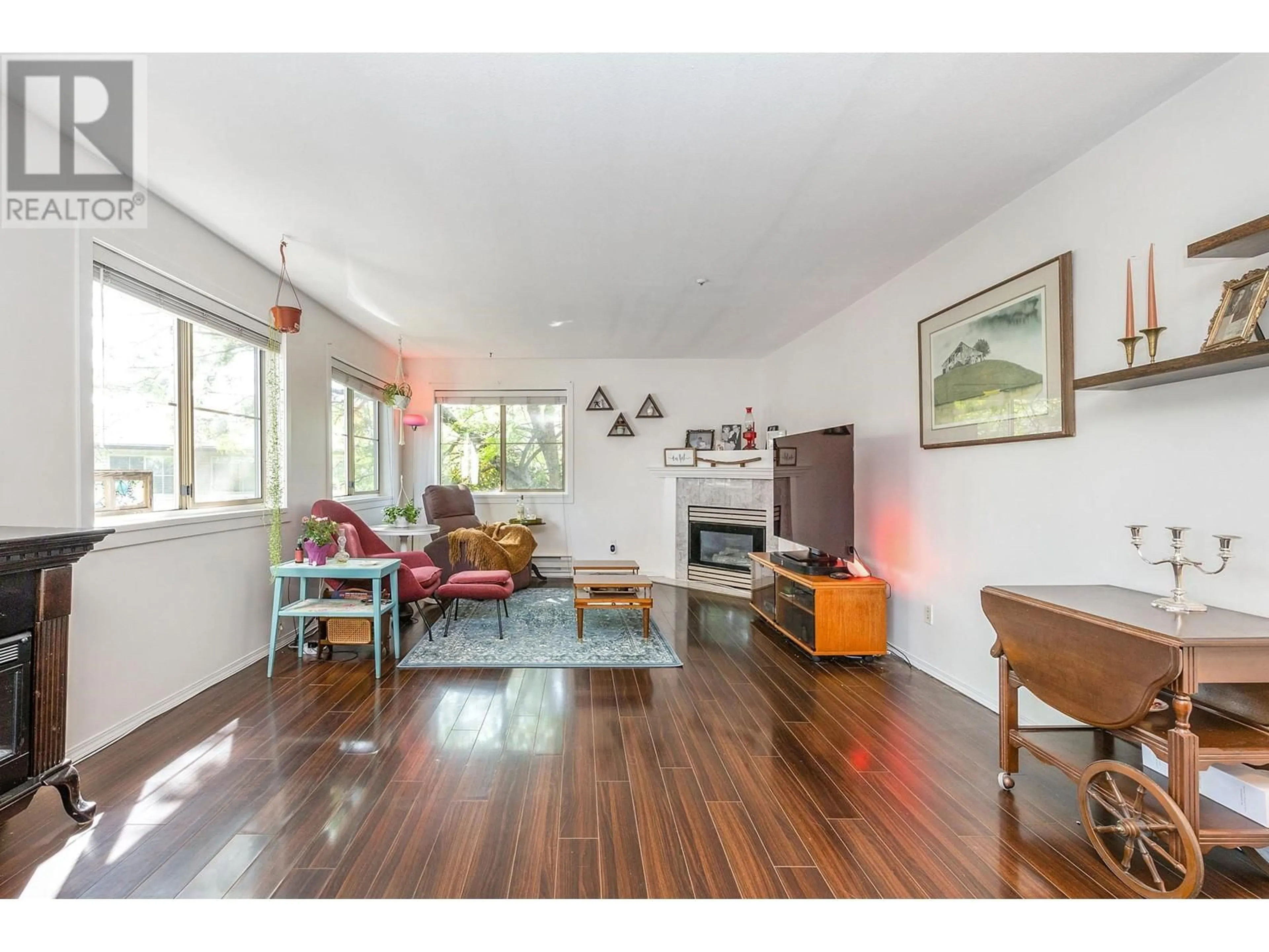 Living room with furniture, wood/laminate floor for 204 - 19130 FORD ROAD, Pitt Meadows British Columbia V3Y2P1
