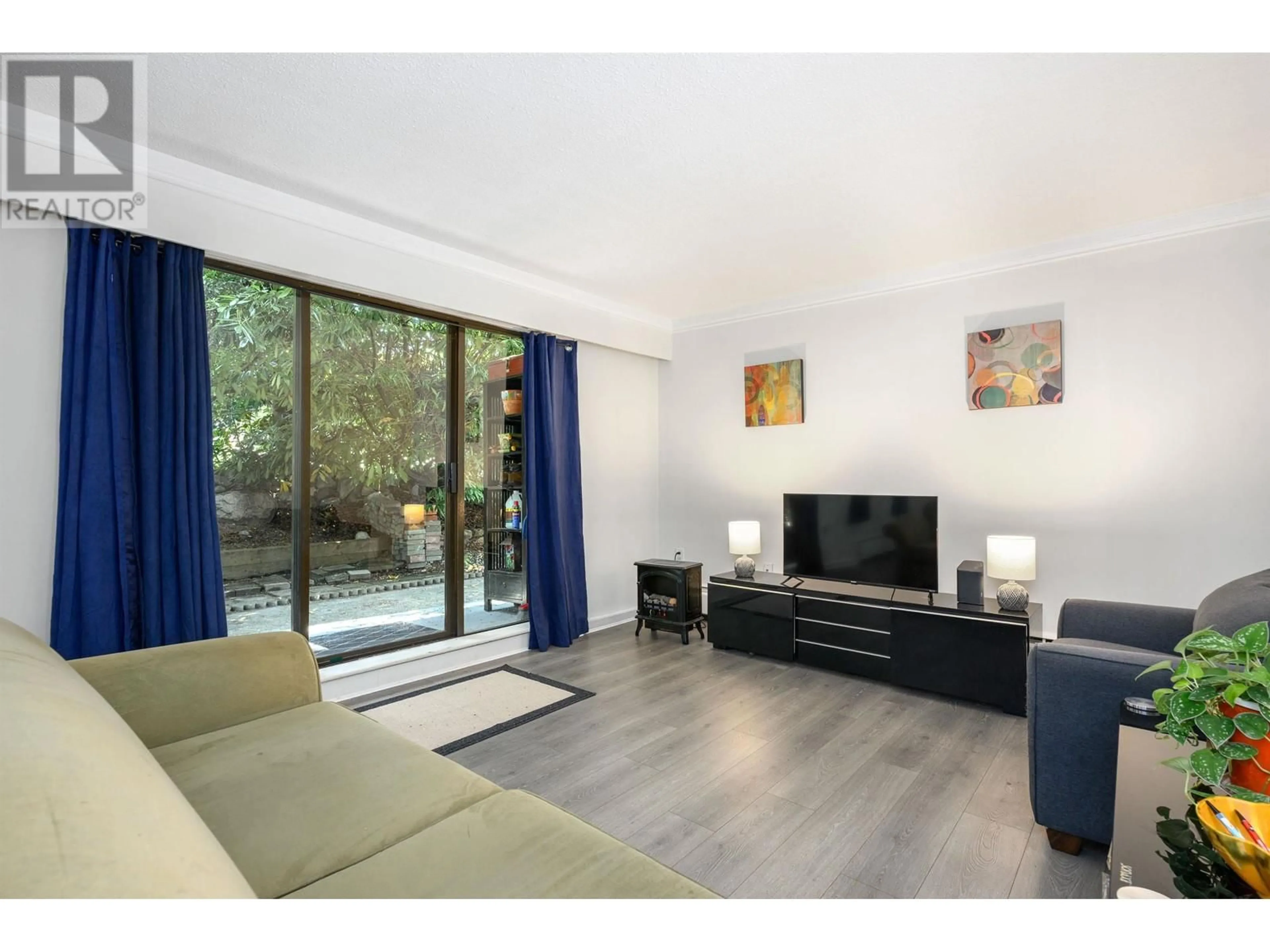 Living room with furniture, wood/laminate floor for 110 - 175 4TH STREET, North Vancouver British Columbia V7L1H8