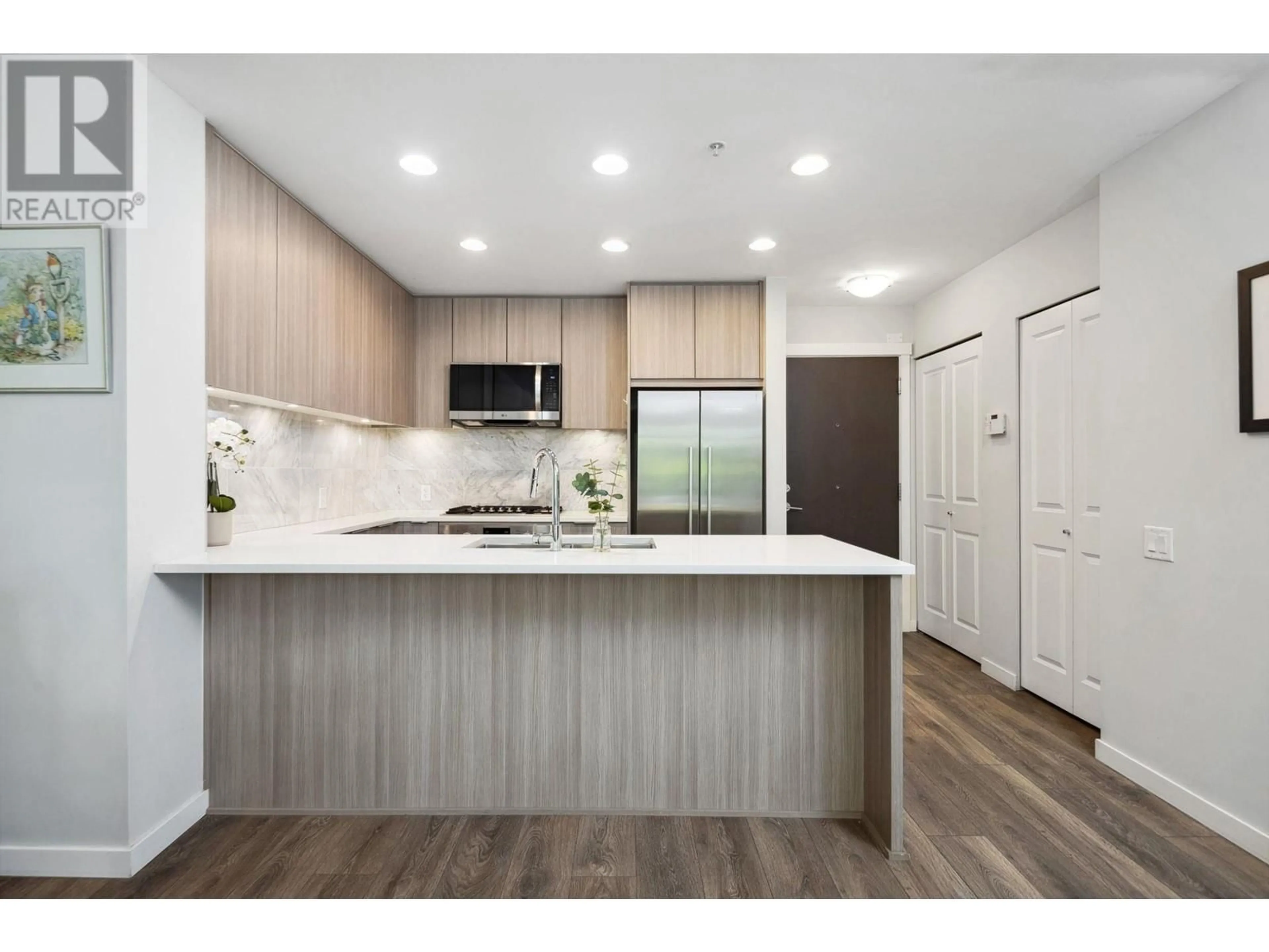 Open concept kitchen, wood/laminate floor for 104 - 3289 RIVERWALK AVENUE, Vancouver British Columbia V5S0G2