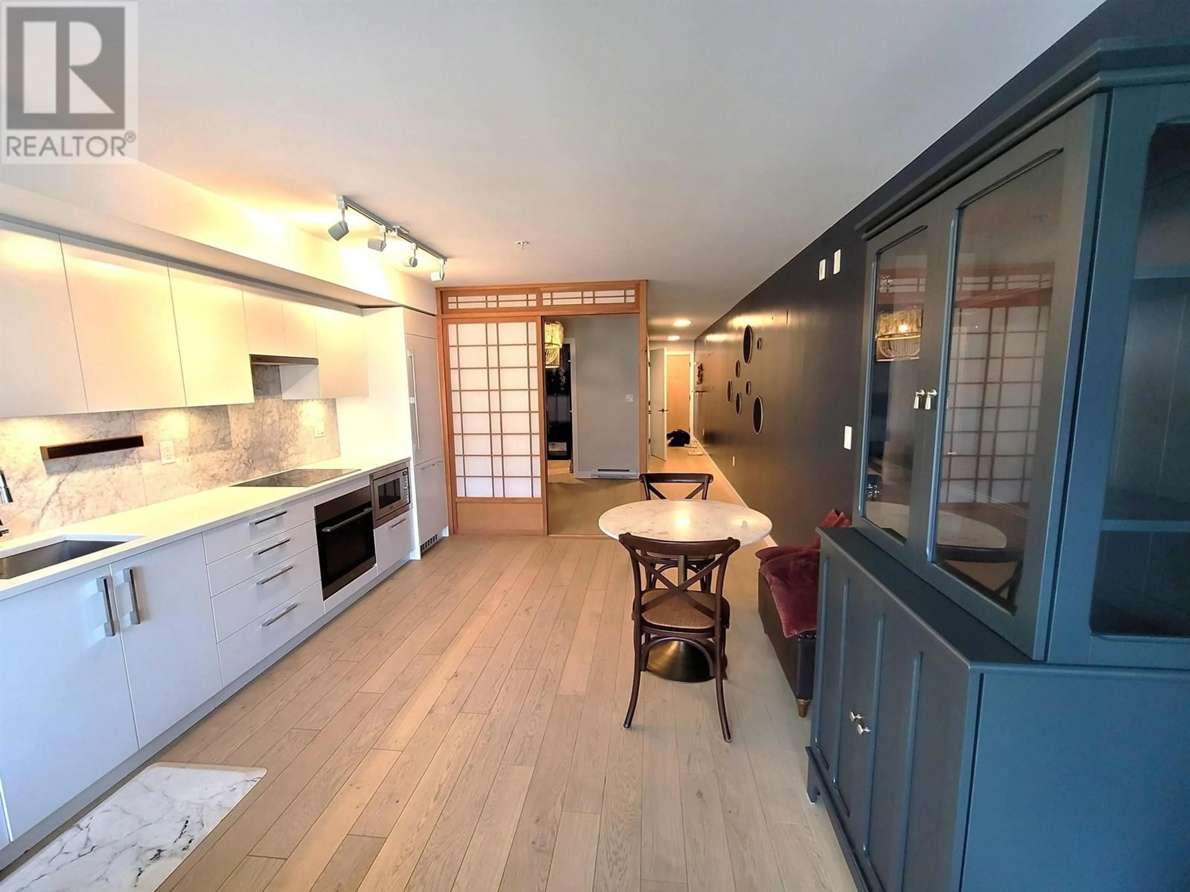 Open concept kitchen, wood/laminate floor for 211 - 2508 FRASER STREET, Vancouver British Columbia V5T1T1