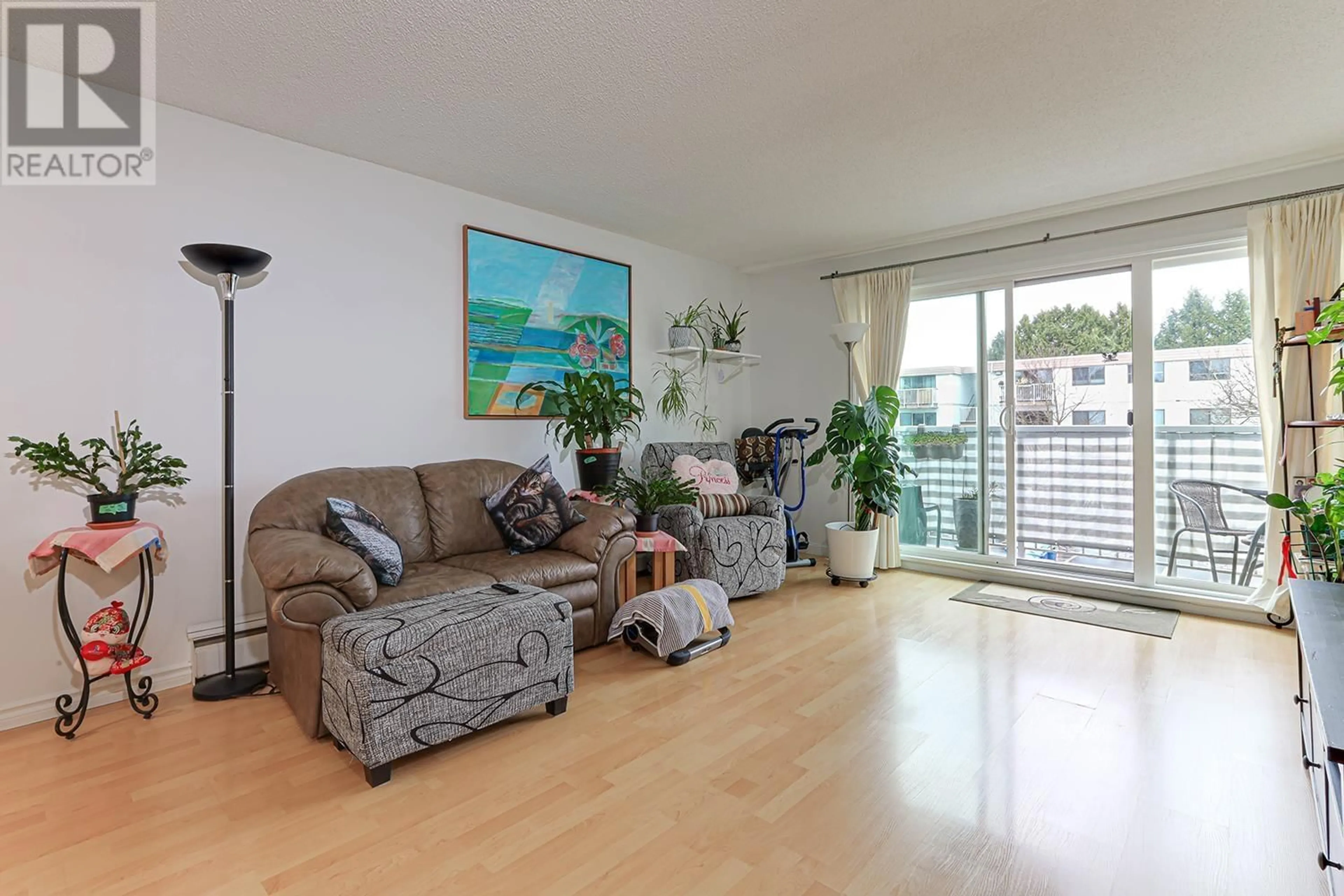 Living room with furniture, wood/laminate floor for 209 - 7260 LINDSAY ROAD, Richmond British Columbia V7C3M6