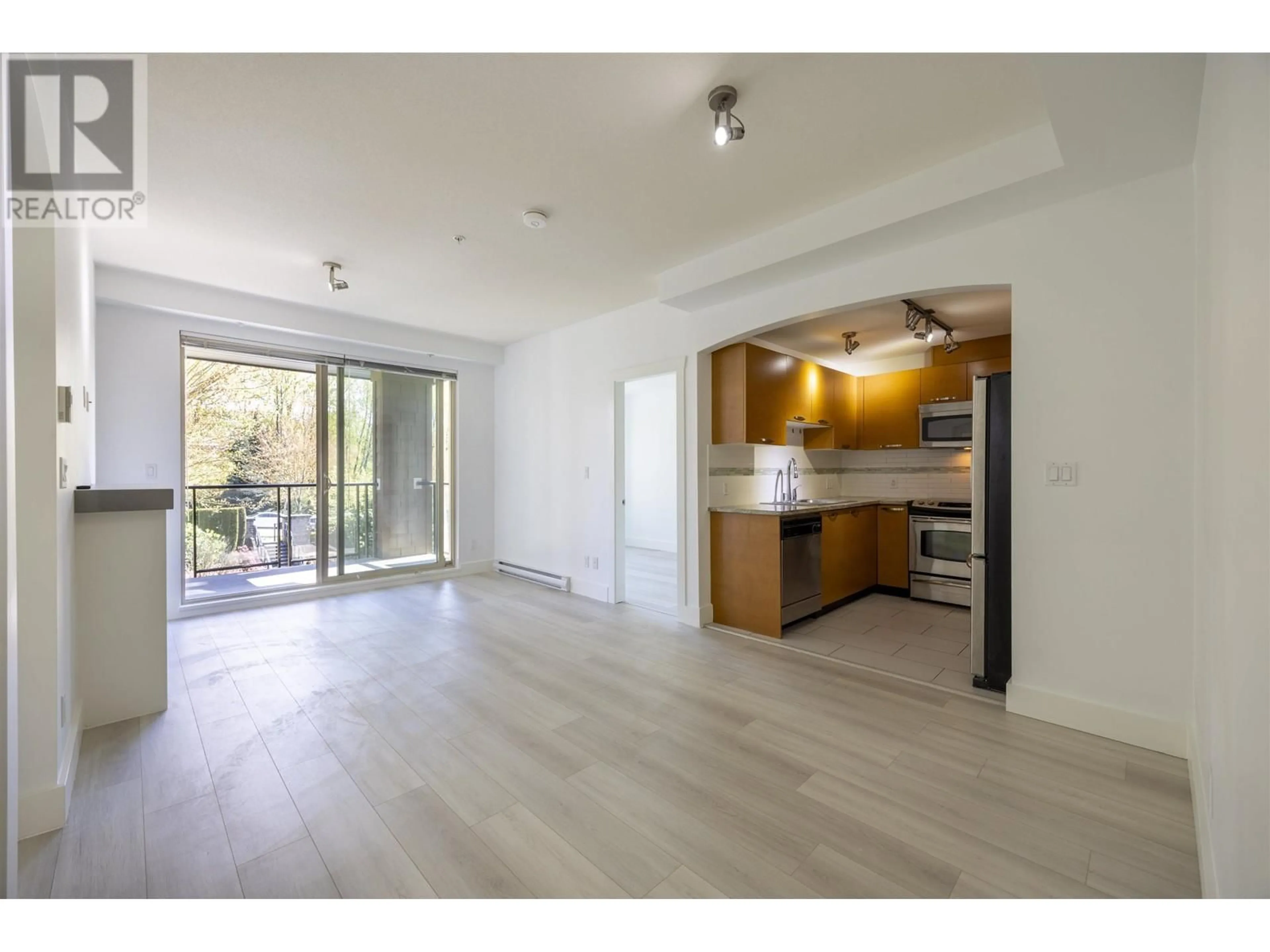 Open concept kitchen, wood/laminate floor for 414 - 7488 BYRNEPARK WALK, Burnaby British Columbia V3N0B6