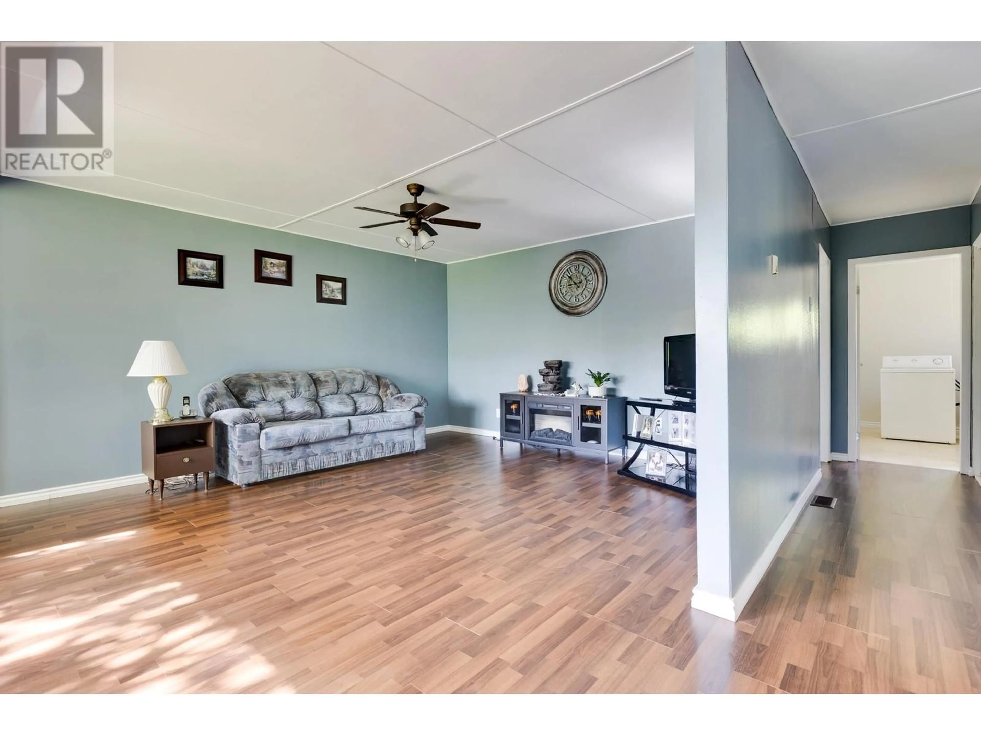 Living room with furniture, wood/laminate floor for 7443 KELLY ROAD, Prince George British Columbia V2K2H4
