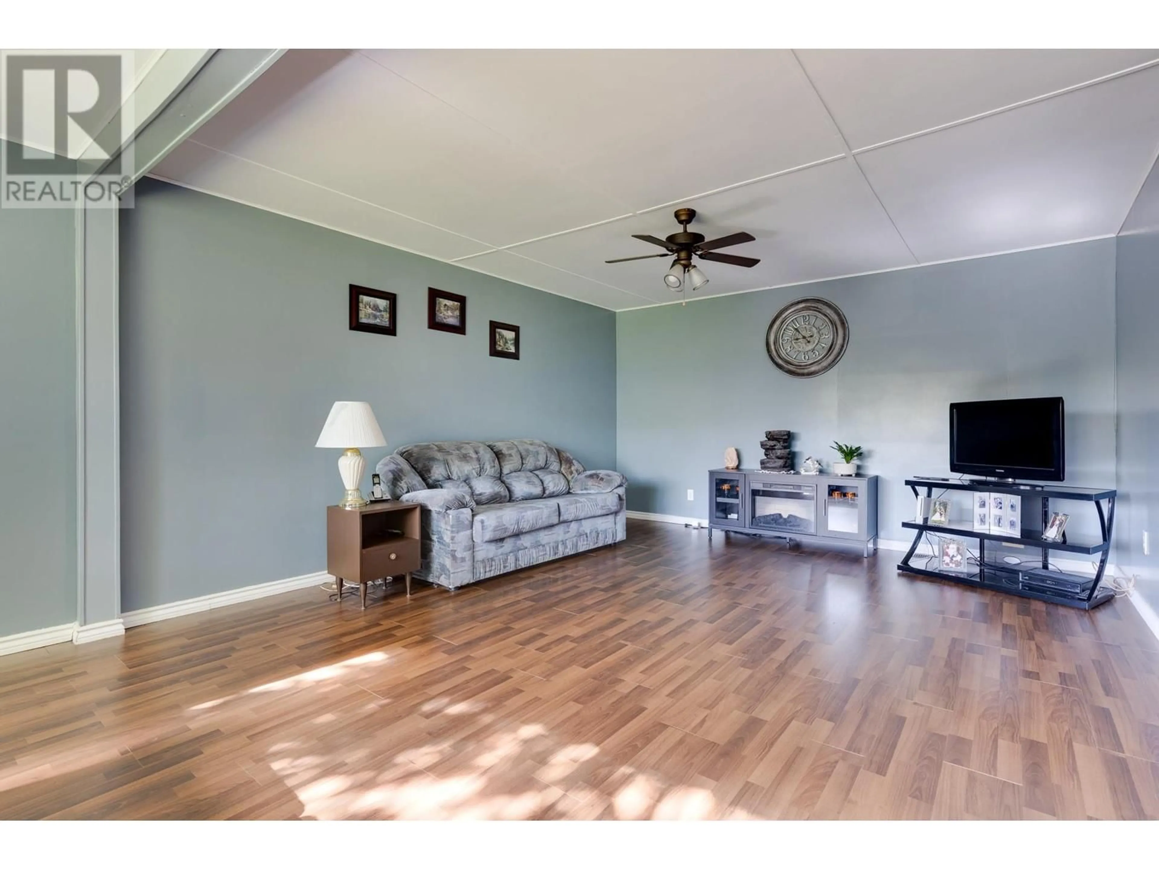 Living room with furniture, wood/laminate floor for 7443 KELLY ROAD, Prince George British Columbia V2K2H4