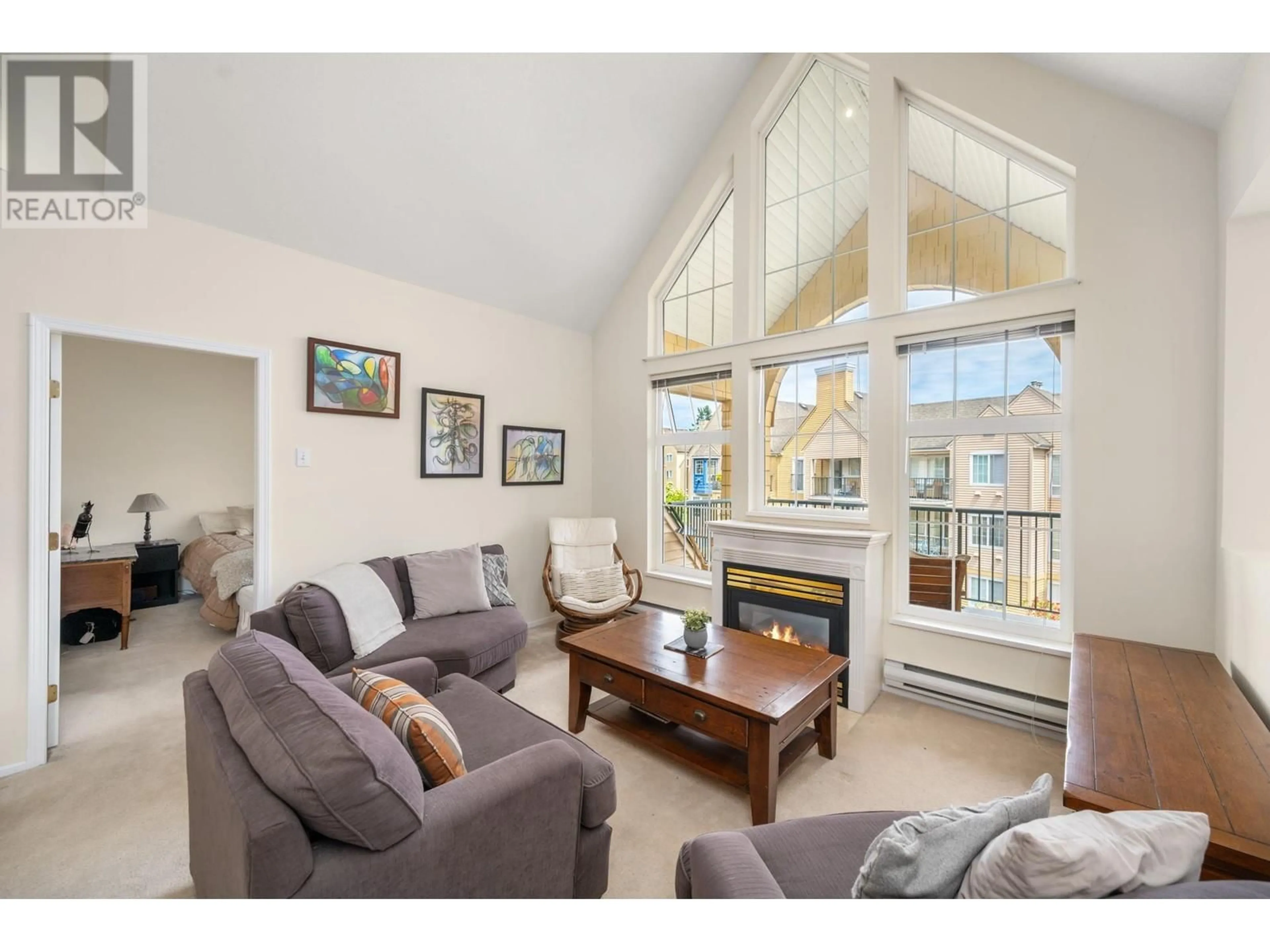 Living room with furniture, wood/laminate floor for 301 - 5555 13A AVENUE, Tsawwassen British Columbia V4M2E7