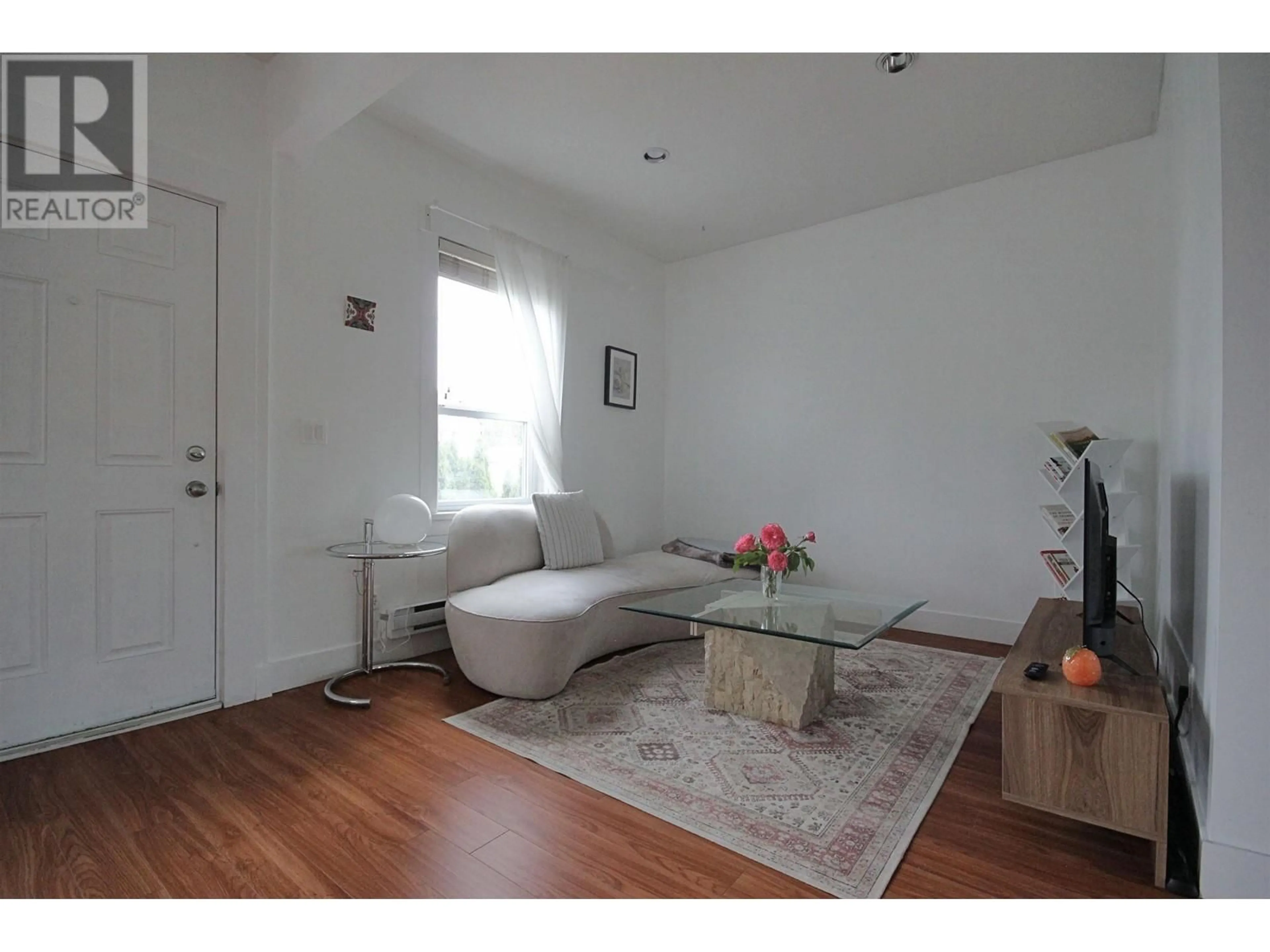 Living room with furniture, wood/laminate floor for 112 KING EDWARD AVENUE, Vancouver British Columbia V5V2C1