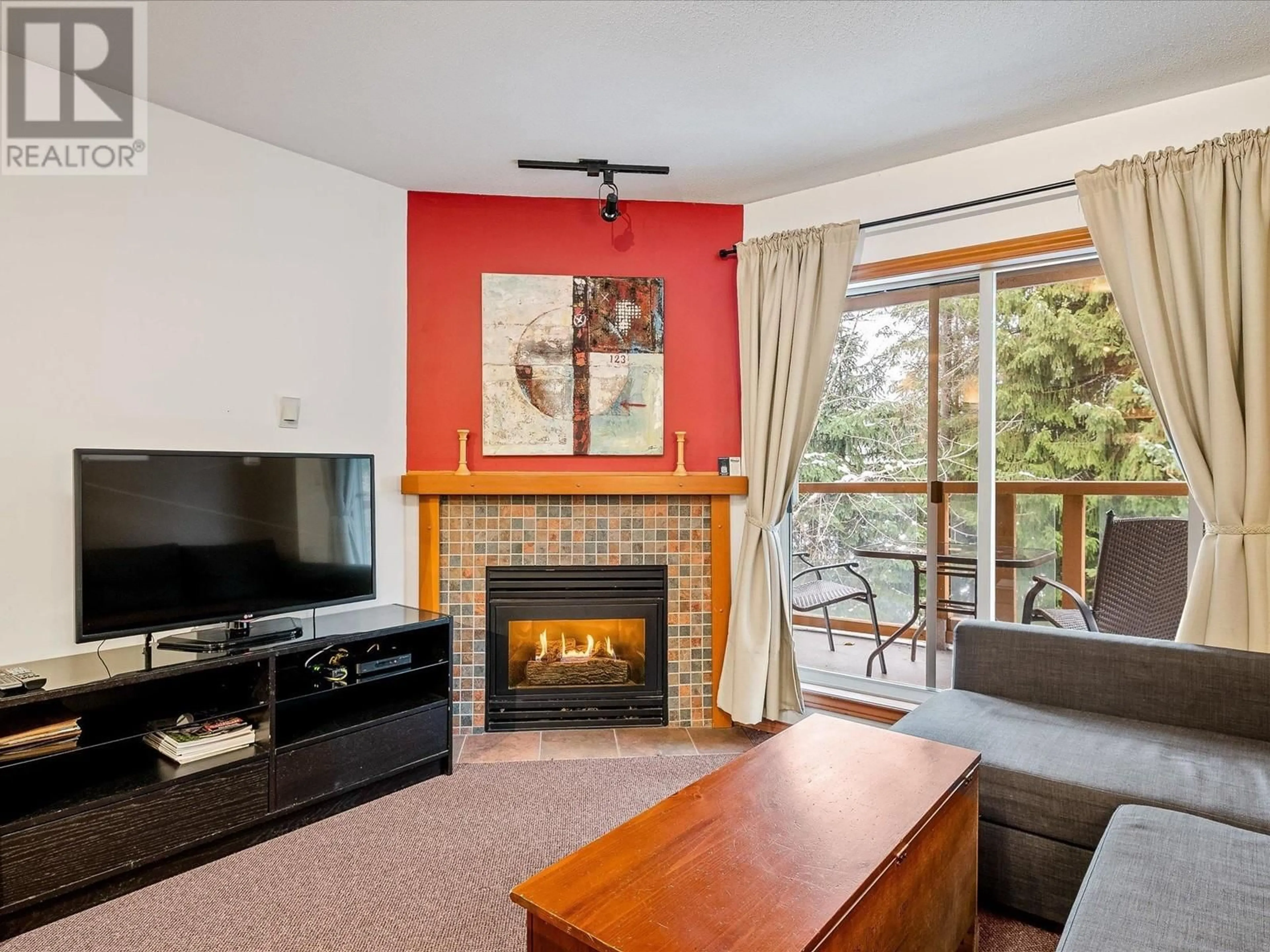 Living room with furniture, wood/laminate floor for 112 - 4388 NORTHLANDS BOULEVARD, Whistler British Columbia V0N1B4
