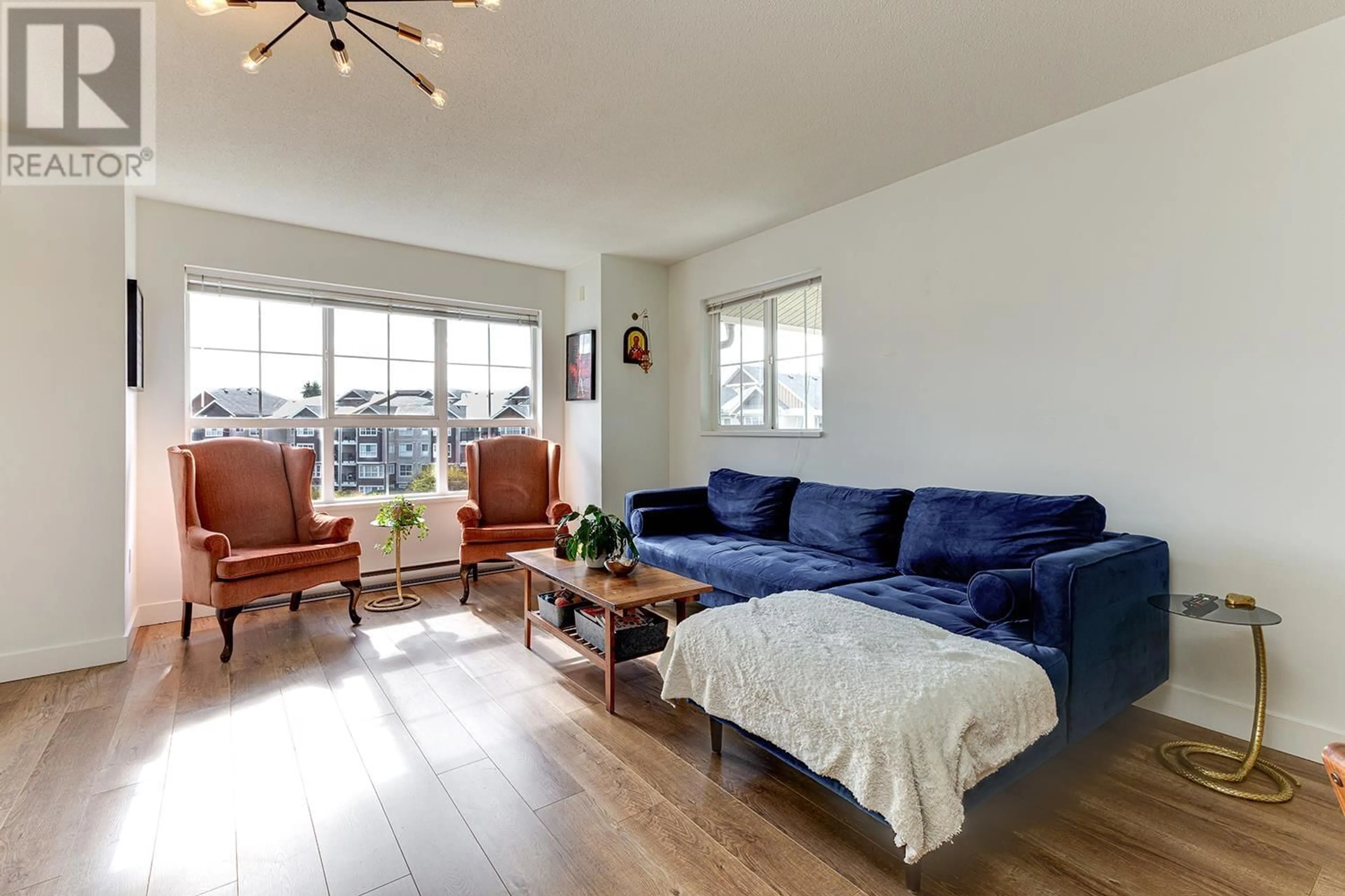 Living room with furniture, wood/laminate floor for 405 - 19673 MEADOW GARDENS WAY, Pitt Meadows British Columbia V3Y0A1