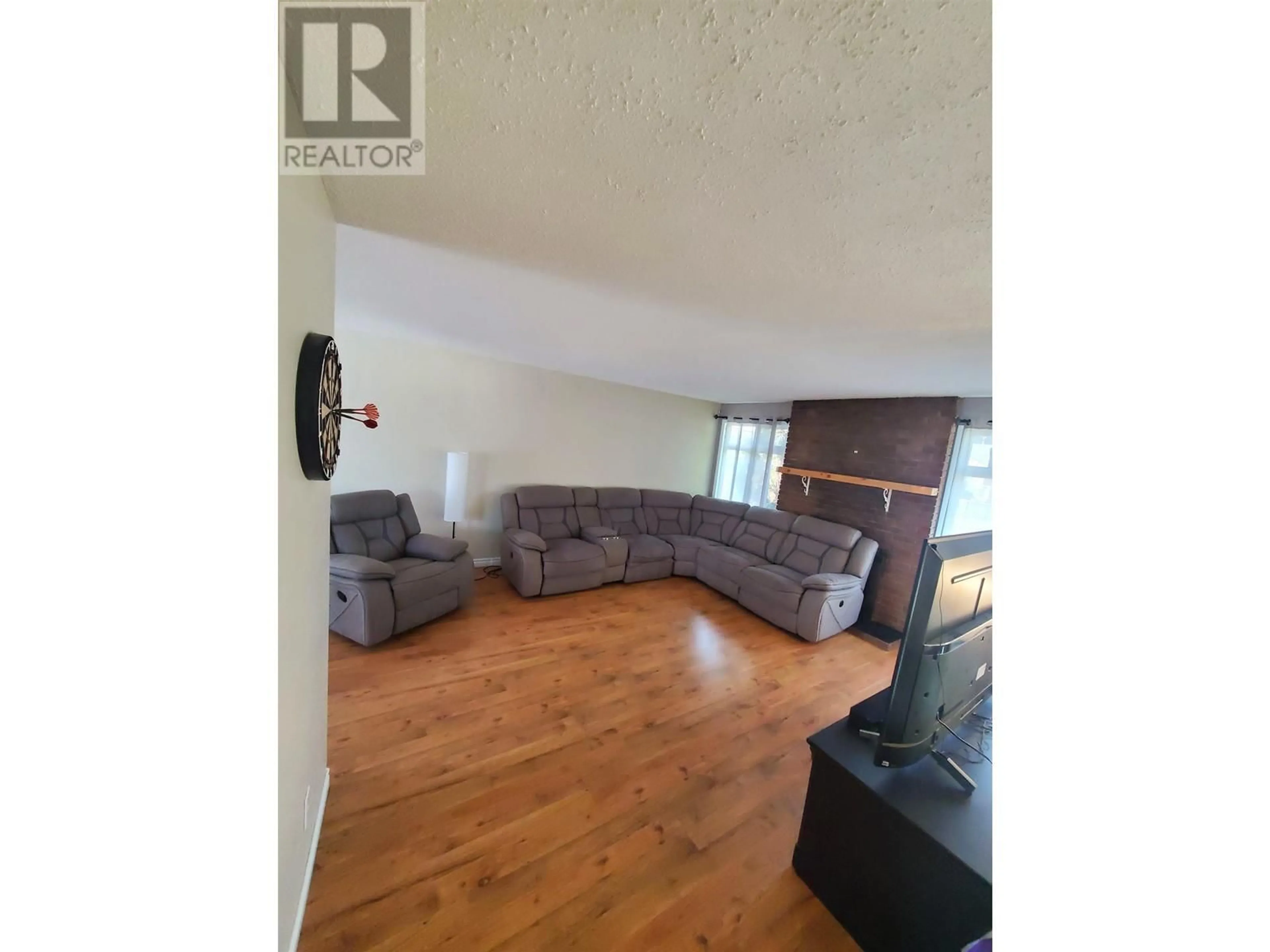 Living room with furniture, wood/laminate floor for 27 MANSON CRESCENT, Mackenzie British Columbia V0J2C0