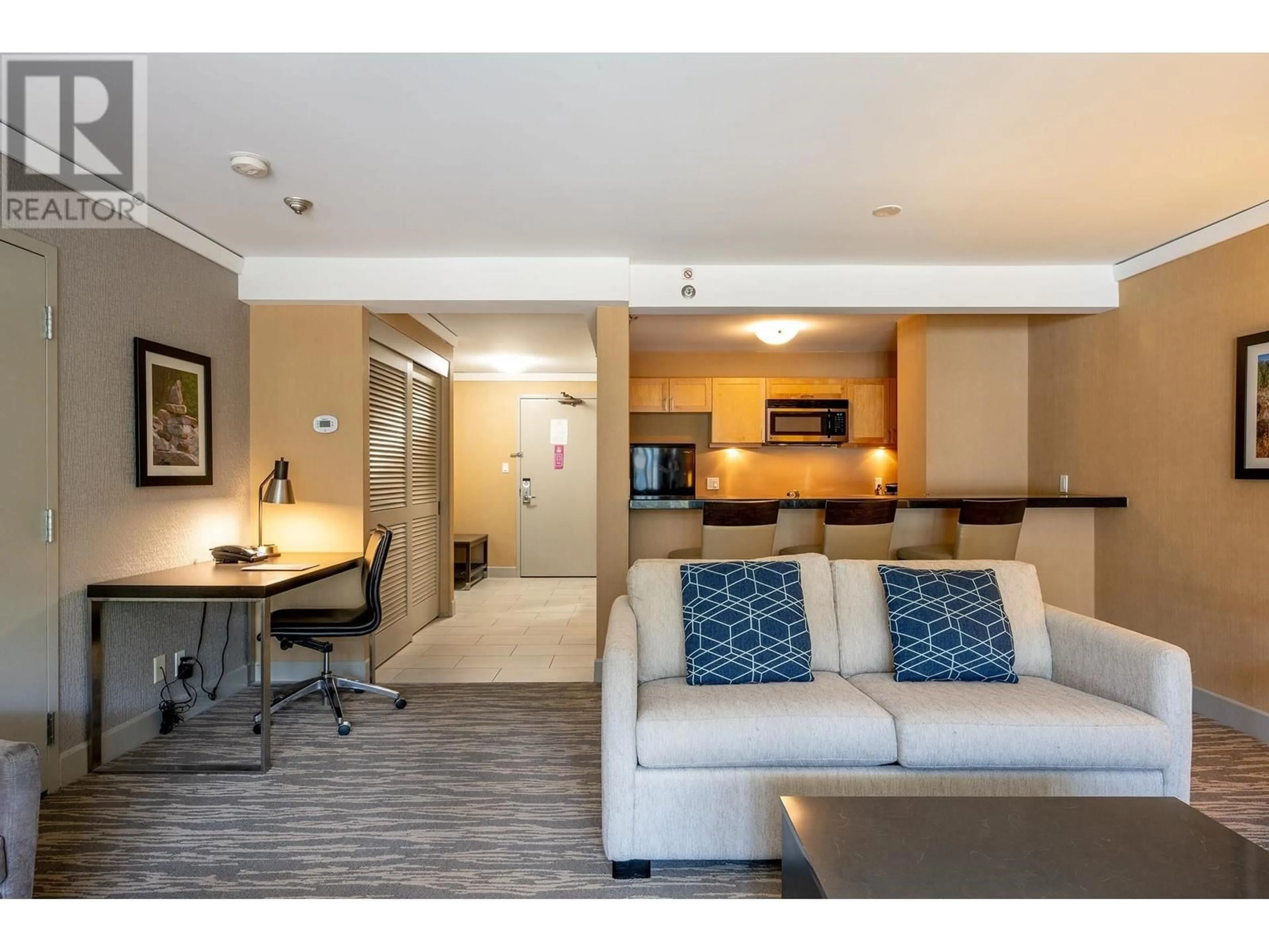 Living room with furniture, wood/laminate floor for 210/212 - 4050 WHISTLER WAY, Whistler British Columbia V8E1H9