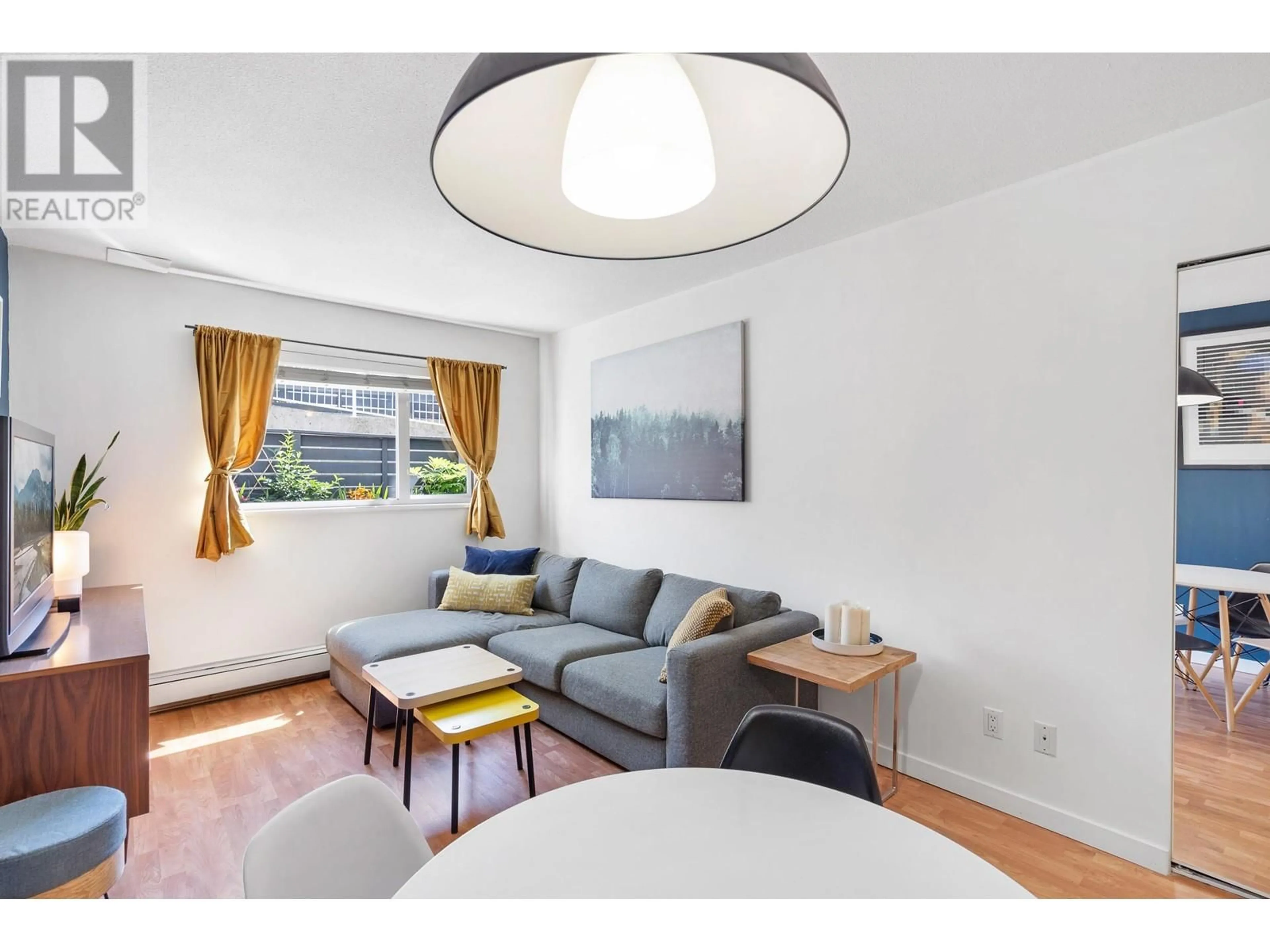 Living room with furniture, wood/laminate floor for 105 - 33 TEMPLETON DRIVE, Vancouver British Columbia V5L3C9