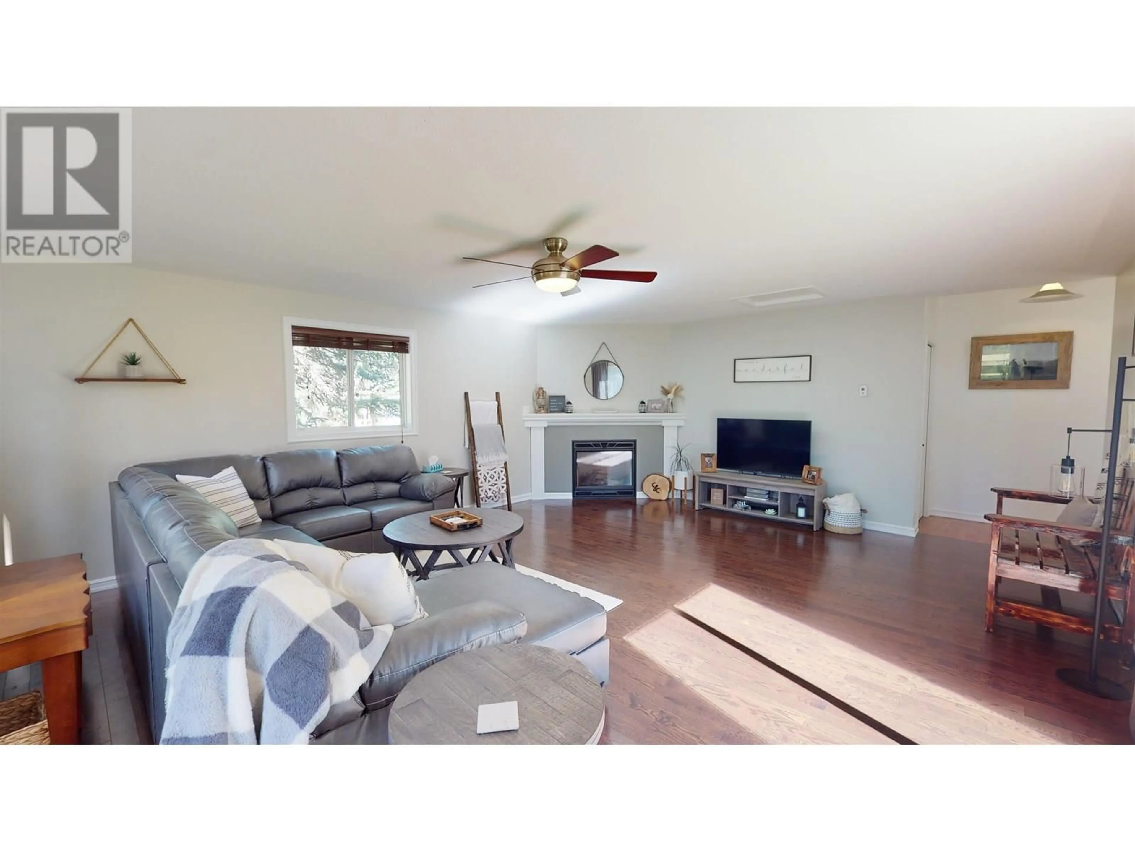 Living room with furniture, wood/laminate floor for 1027 LUND ROAD, Houston British Columbia V0J1Z1