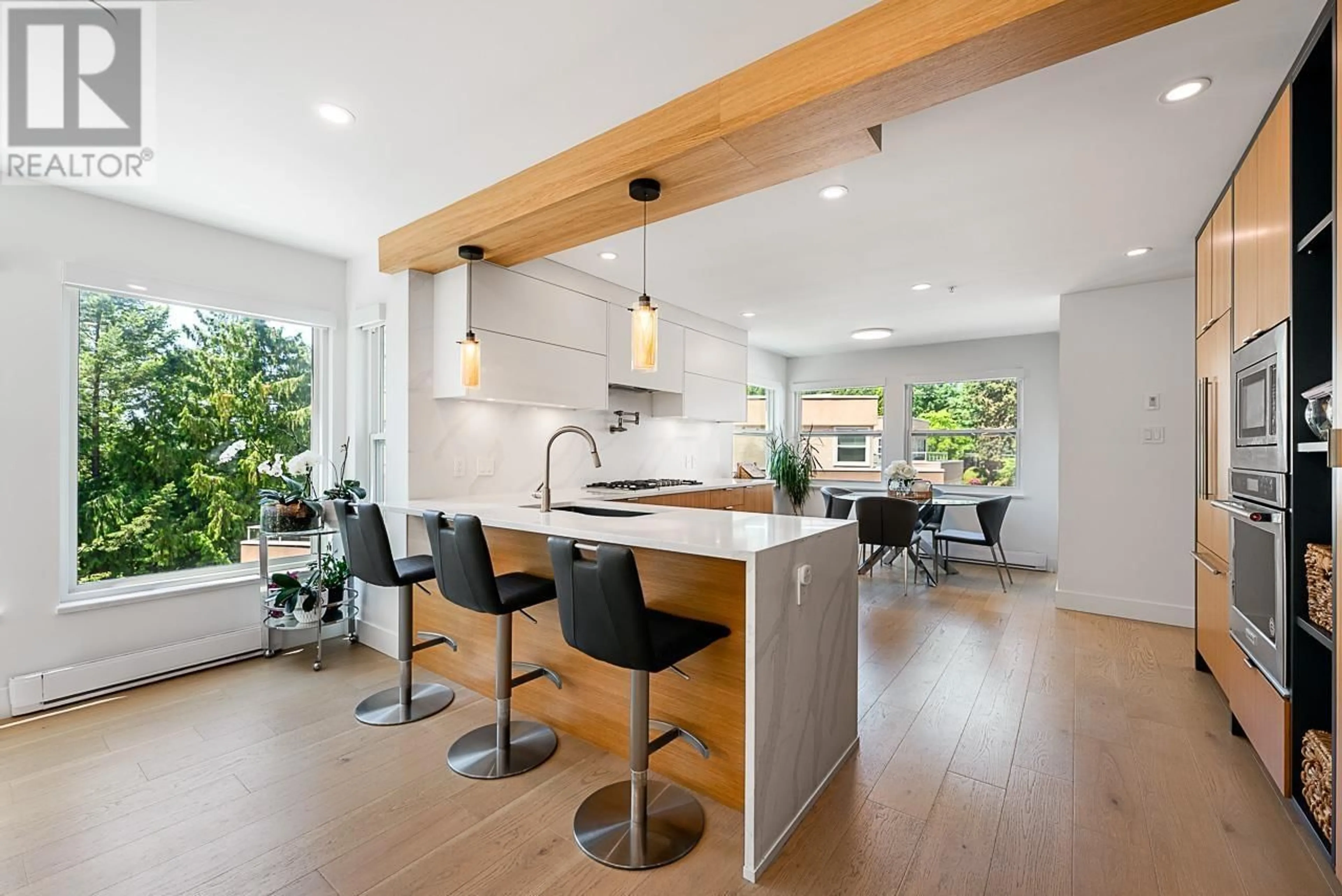 Open concept kitchen, wood/laminate floor for 11 - 2425 EDGEMONT BOULEVARD, North Vancouver British Columbia V7P2L2