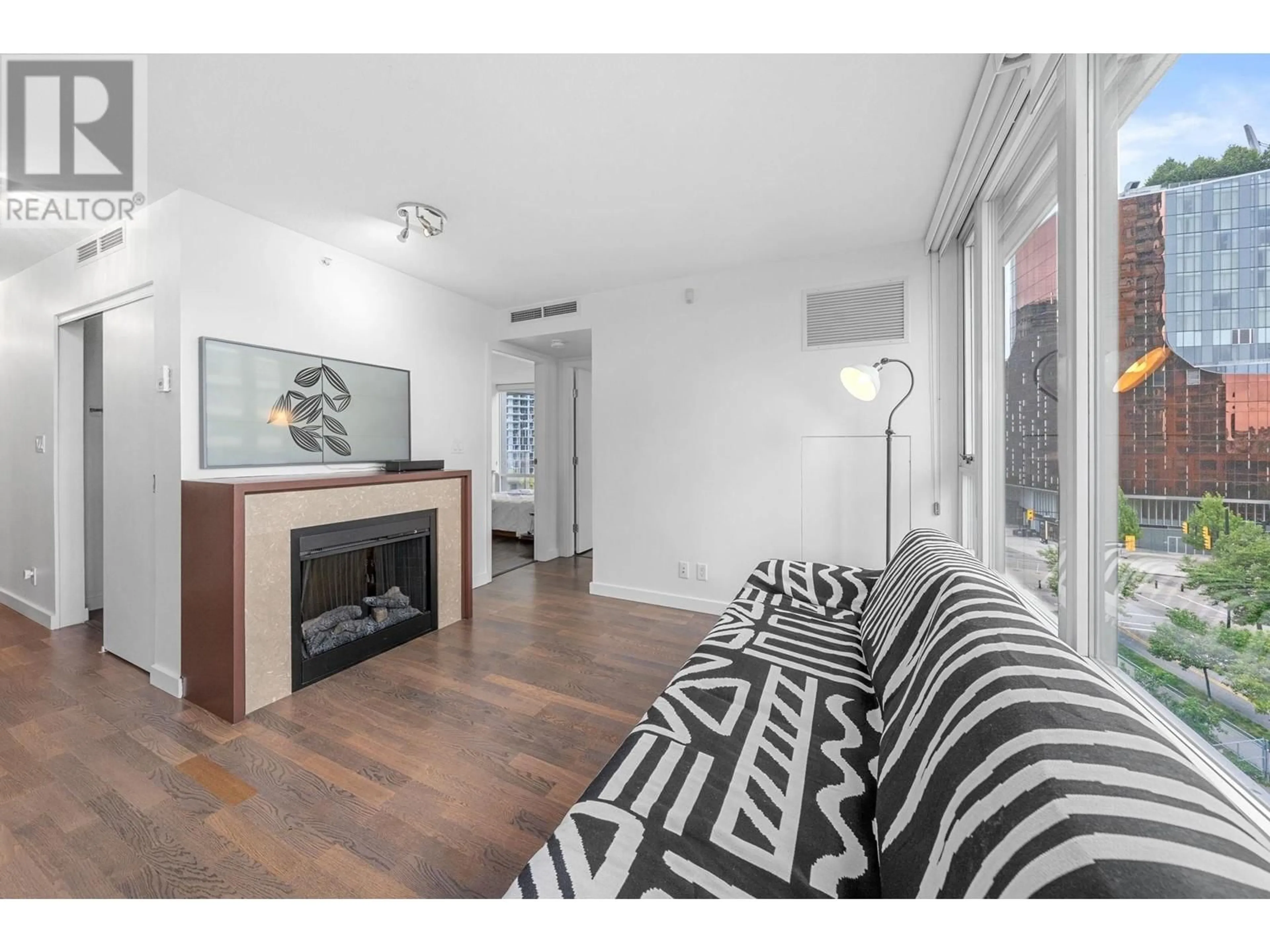 Living room with furniture, wood/laminate floor for 702 - 918 COOPERAGE WAY, Vancouver British Columbia V6B0A7