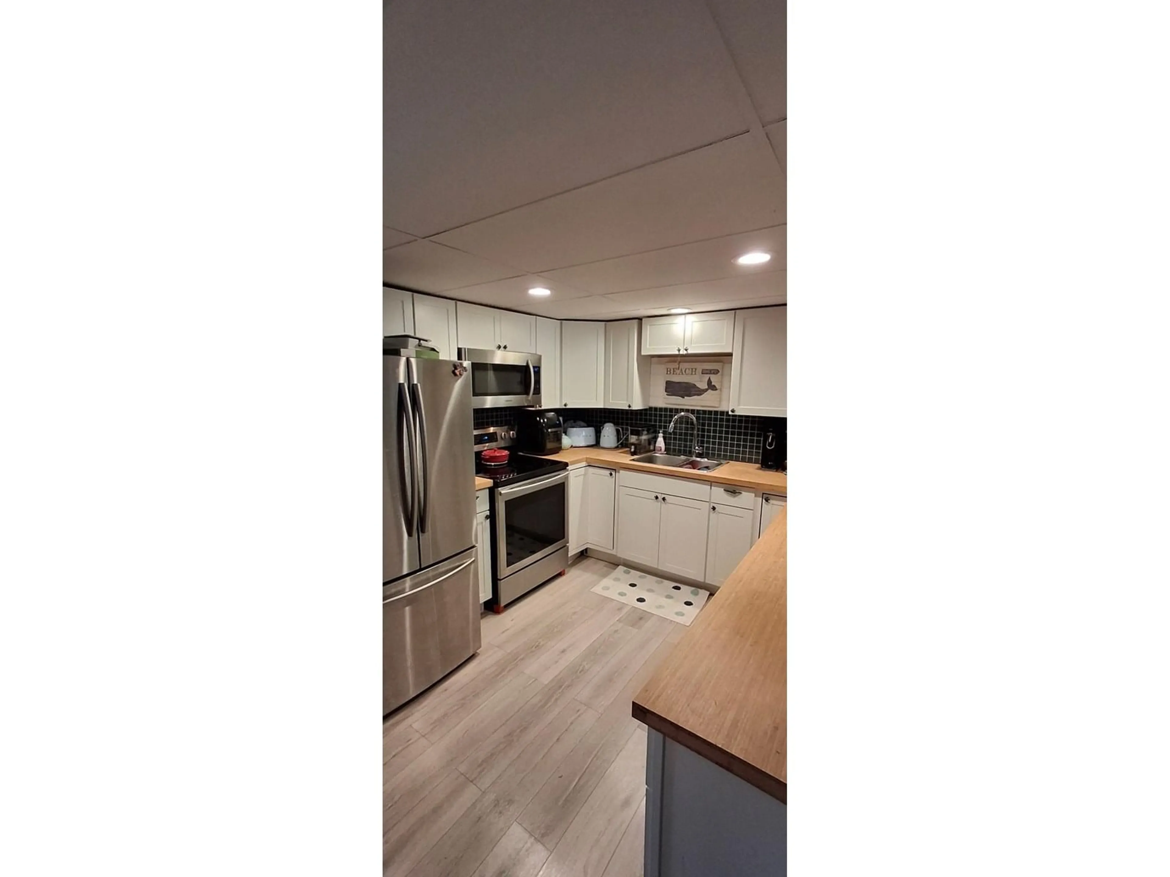 Open concept kitchen, wood/laminate floor for 10833 85A, Delta British Columbia V4C2V2
